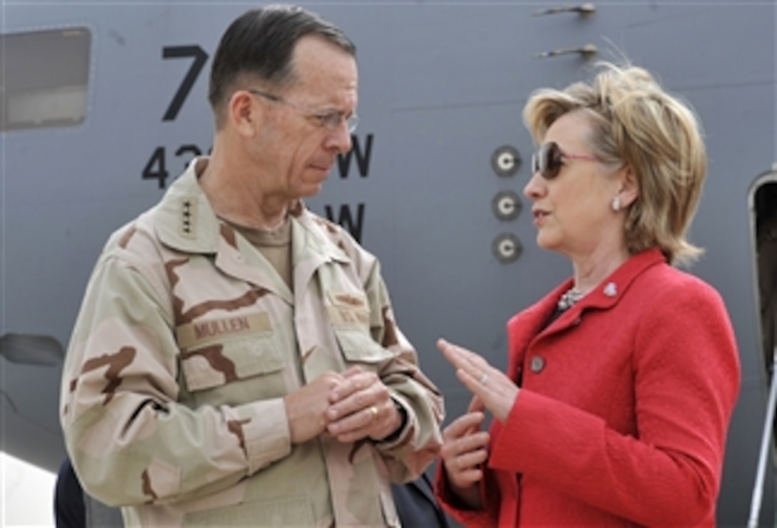 Secretary of State Hillary Clinton talks with the Chairman of the Joint Chiefs of Staff Adm. Mike Mullen, U.S. Navy, on the flight line of Sather Air Base in Baghdad, Iraq, on April 25, 2009.  Clinton is making an unannounced visit to meet with U.S. military leaders and top Iraqi government officials.  Clinton also will hold a town hall meeting with U.S. service members and Iraqi civilians.  