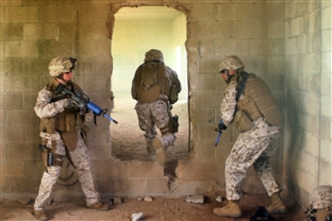 Former Special Reaction Team members clear a smoke-filled room during a demonstration for a Military Police Company during an exercise for its upcoming deployment to Afghanistan at Military Operations on Urban Terrain, Camp Pendleton, Calif., April 24, 2009. The Marines are assigned to the Combat Logistics Regiment 17, 1st Marine Logistics Group.