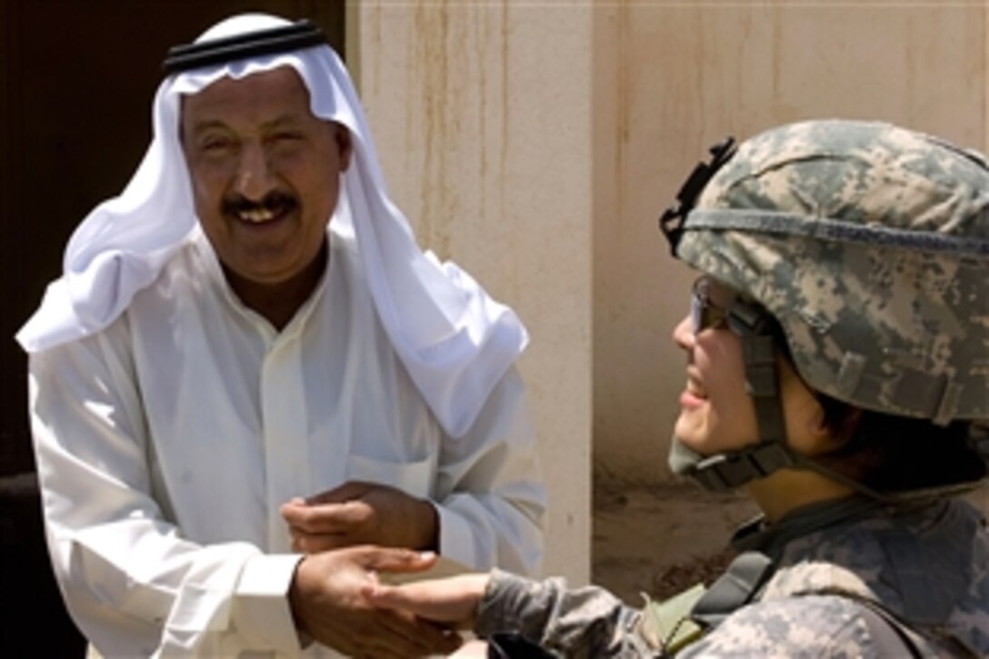 U.S. Army Staff Sgt. Kay Izumihara shakes hands with a local sheik in Kirkuk, Iraq, April 26, 2009. 
Izumihara is assigned to the 490th Civil Affairs Company, 321st Civil Affairs Brigade, 353rd Civil Affairs Command, U.S. Army Civil Affairs and Psychological Operations Command.