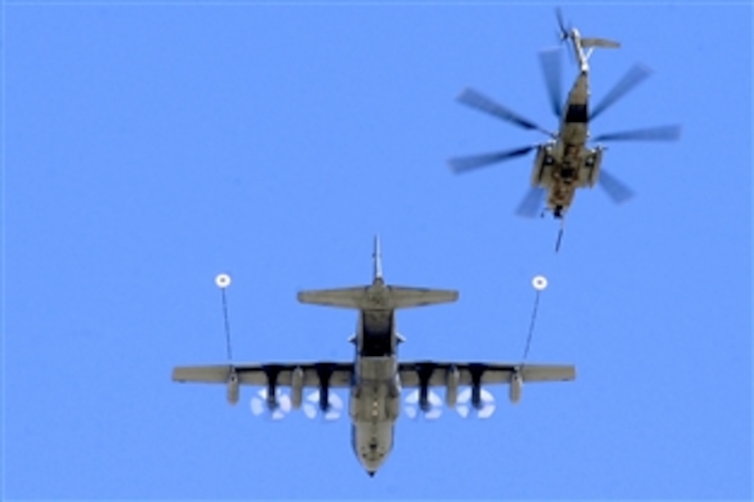 A U.S. Marine CH-53E Super Stallion helicopter approaches an Air Force C-130P aircraft during a helicopter air refueling mission over Grand Bara, Djibouti, April 23, 2009. The helicopter crew is assigned to the Marine Heavy Helicopter Squadron Four Six One, and the aircraft crew is assigned to the 81st Rescue Squadron. The helicopter received 13,800 pounds of fuel during the 45-minute mission. 