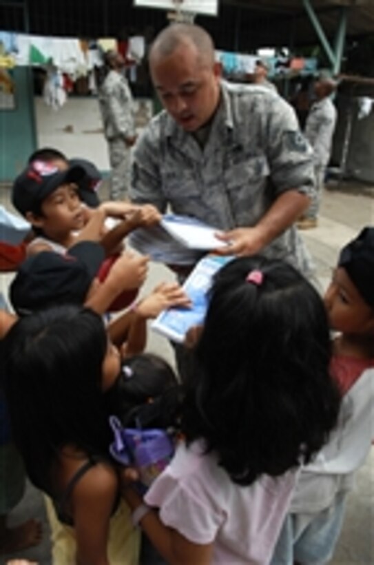 U.S. Air Force Tech. Sgt. Luis Angel Aviles hands out toys and school supplies to the children of Duyan Ni Maria Children's Home during a community relations event in Angeles City, Philippines on April 24, 2009.  