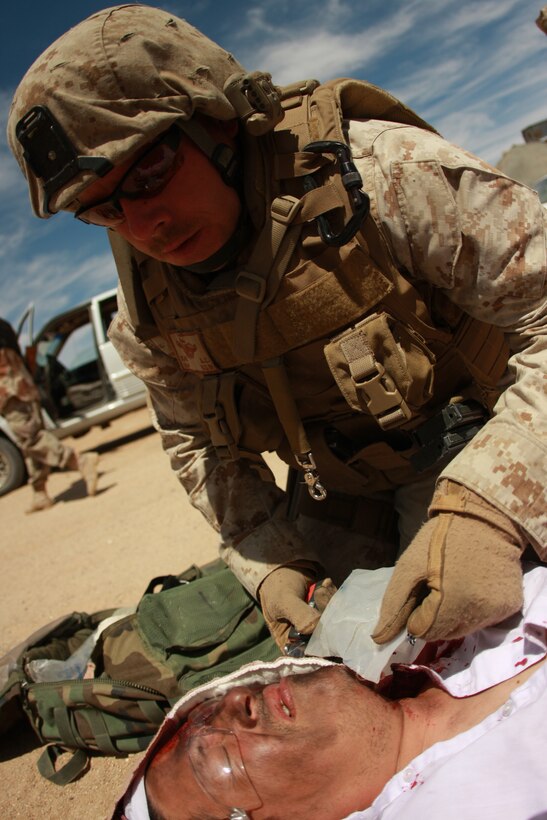 Petty Officer 2nd Class Anthony Kaer, a corpsman training at the Advisor Training Group, tends to a casualty May 1 after the team encountered a mock improvised explosive device during a patrol in the Combat Center’s Gypsum Ridge training area.