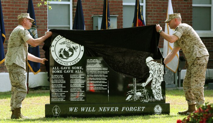 Sgt. Maj. Luke T. Converse, battalion sergeant major, and Lt. Col. Thomas E. Gratten, battalion commander, 2nd Light Armored Reconnaissance Battalion, 2nd Marine Division, unveil a granite memorial engraved with the names of 21 Marines who died in support of Operations Just Cause, Enduring Freedom and Iraqi Freedom.  The memorial was unveiled the day before Marines from 2nd LAR deployed to Afghanistan as part of the 2nd Marine Expeditionary Brigade.  Gratten said it was important before deployment to remember those who have fought before and the sacrifice they have made.  (Official U.S. Marine Corps Photo by Cpl. Meghan J. Canlas) (RELEASED)