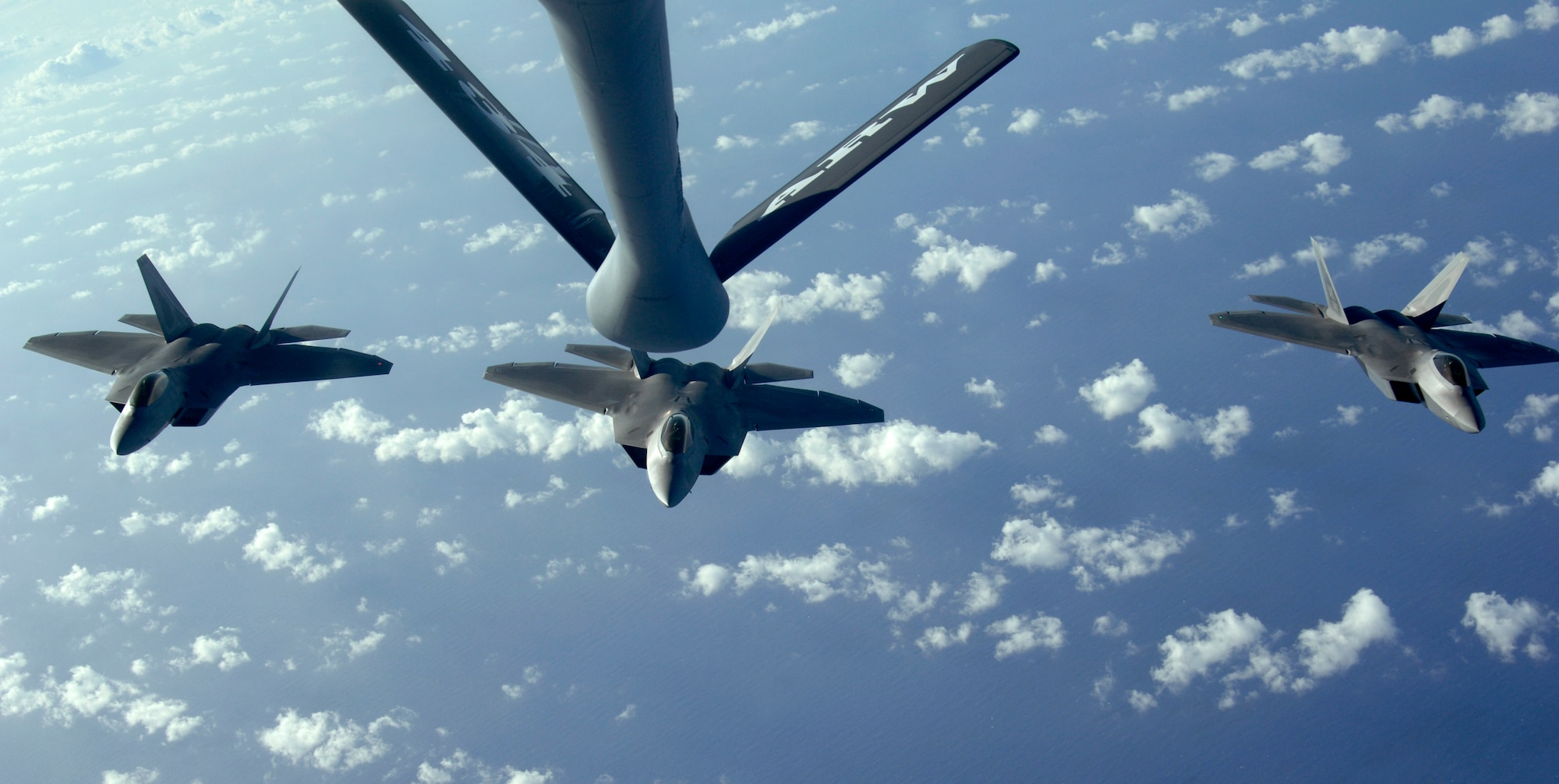 A three ship of F-22 Raptors move into refueling position to receive fuel from a KC-135 Stratotanker over the Pacific Ocean.  The 434th Air Refueling Wing from Grissom Air Reserve Base, Indiana recently completed a deployment to Andersen in support of Pacific Refueling Operations. During the 120 day deployment they accomplished 162 missions, flew 654 hours, off loaded over 8.2 million pounds of fuel with an overall mission capability rate of 96.2 percent. The 452nd Air Mobility Wing, March Air Reserve Base, Calif., will take over Andersen refueling operations. 
 
(U.S. Air Force photo/ Master Sgt. Kevin J. Gruenwald) released

















  












 











































  












 

























