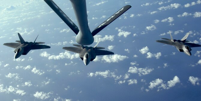 A three ship of F-22 Raptors move into refueling position to receive fuel from a KC-135 Stratotanker over the Pacific Ocean. The 434th Air Refueling Wing from Grissom Air Reserve Base, Indiana recently completed a deployment to Andersen in support of Pacific Refueling Operations. During the 120 day deployment they accomplished 162 missions, flew 654 hours, off loaded over 8.2 million pounds of fuel with an overall mission capability rate of 96.2 percent. The 452nd Air Mobility Wing, March Air Reserve Base, Calif., will take over Andersen refueling operations. (U.S. Air Force photo/Master Sgt. Kevin J. Gruenwald)