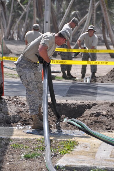 ROI-NAMUR, Marshall Islands - Civil Engineer Airmen work to connect tubes to water tanks to replenish the water supply here that was ruined by unusually high tides in the early part of February. The Airmen have treated more than 1,840,000 gallons of water since their arrival on Feb. 4, 2009. Three of the team members are from Kadena Air Base, Japan, and three are from Eielson Air Force Base, Alaska. (U.S. Air Force photo/Tech. Sgt. Cohen A. Young)