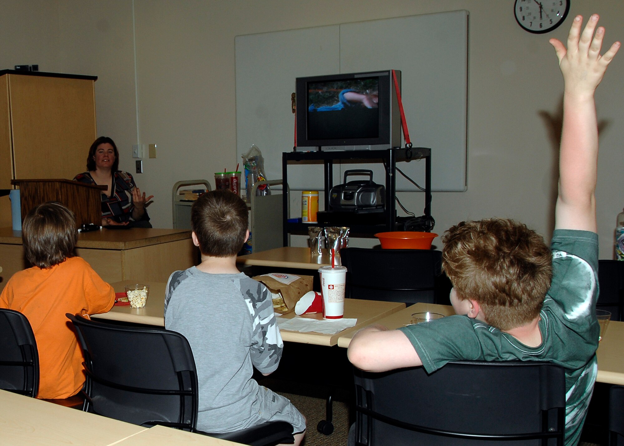 MCCONNELL AIR FORCE BASE, Kan. -- Gretchen Huber, 22nd Force Support Squadron library technician, shows the movie “Shilo” to preschool children at the base library, April 23. When the children finish reading a book they watch the corresponding movie to compare the differences in the story. (Photo by Senior Airman Anthony Mejia)