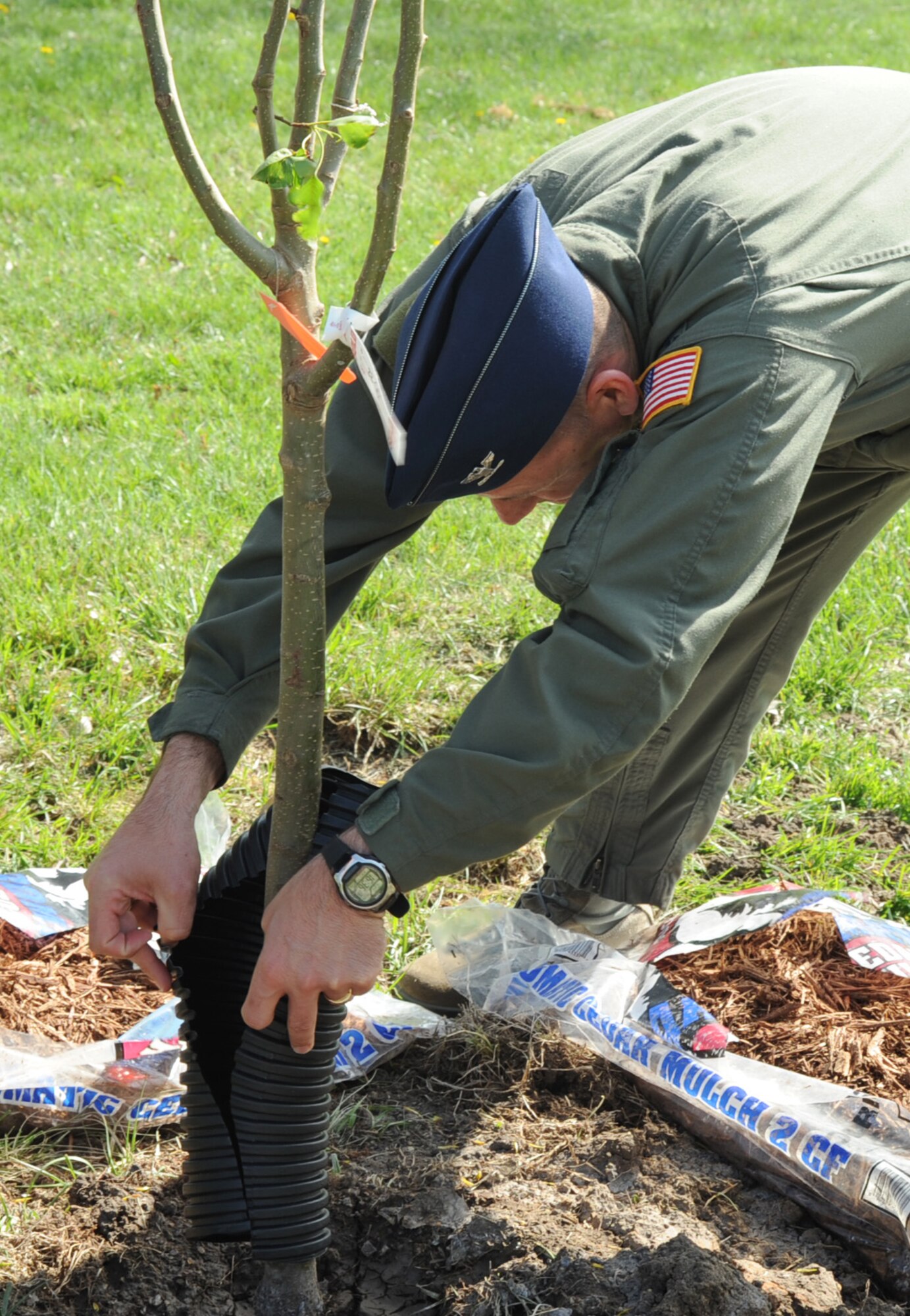 MCCONNELL AIR FORCE BASE, Kan. -- Col. James C. Vechery, 22nd Air Refueling Wing commander, plants a tree in honor of Arbor Day at McConnell AFB, April 24. Girl Scout troop 117 members were in attendance for the 16th annual tree planting dedication. (Photo by Senior Airman Laura Suttles)