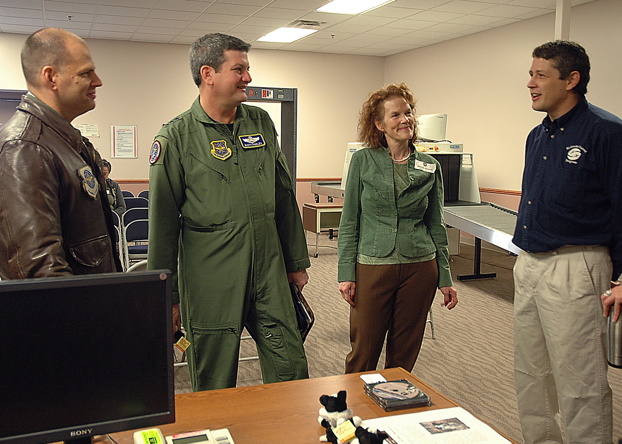 MCCONNELL AIR FORCE BASE, Kan.—Col. James C. Vechery, 22nd Air Refueling Wing commander, Lt. Gen. Vern M. “Rusty” Findley, Air Mobility Command vice commander, and Sharon Hamric, 22nd ARW public affairs, listen to Dr. Nicholas Carter, Principle Ecologist for the Birdstrike Control Program. Mr. Carter described to the group about the use of trained border collies to scare away birds from the McConnell runway area. A group of over 25 local landowners who allow McConnell access to their property for bird control, flew on a KC-135 for an orientation flight on April 24. The landowners were given a first-hand look at how they are helping to protect Team McConnell and their neighbors. (Photo by Tech. Sgt. Genevieve Morris)