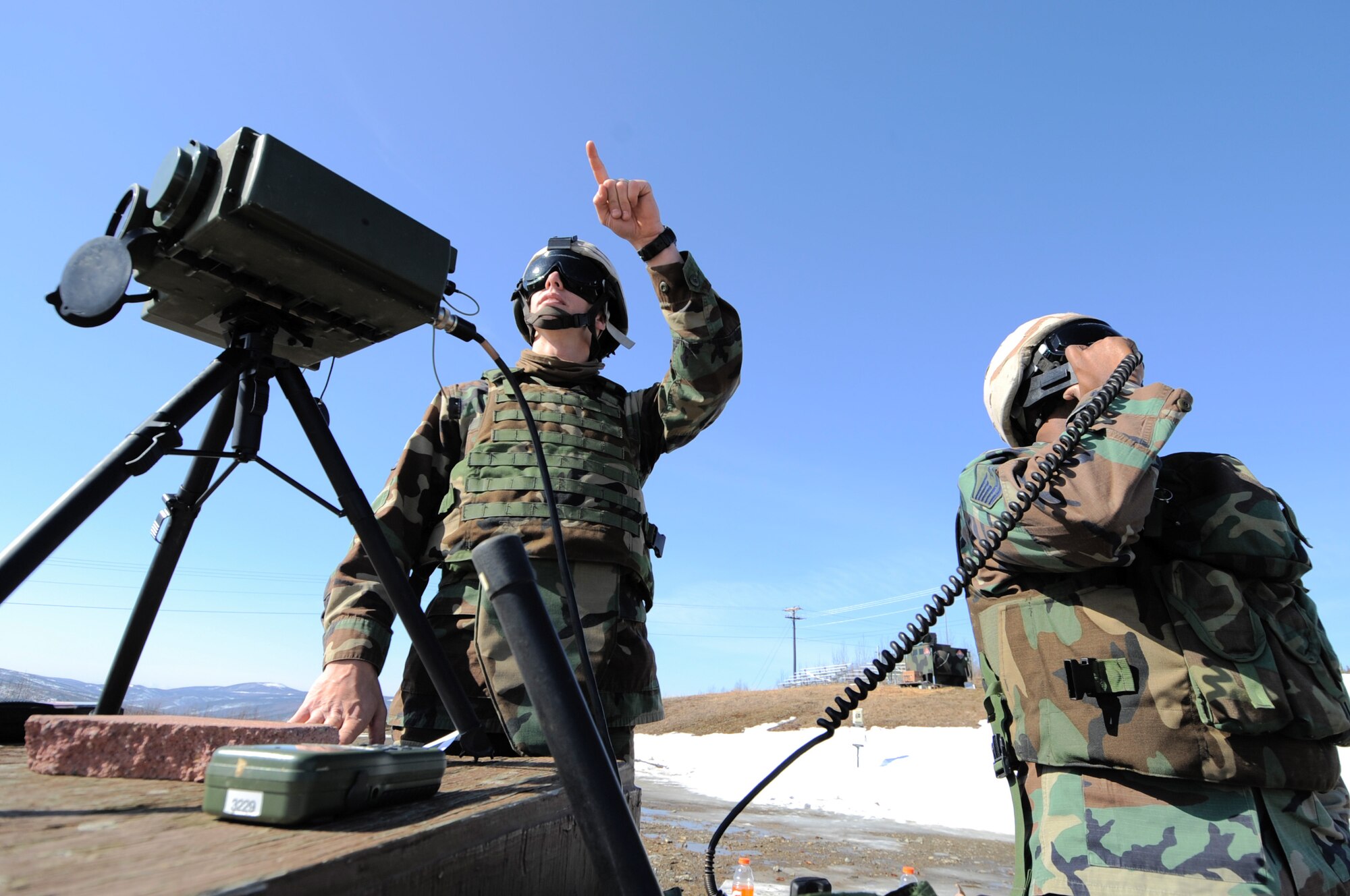 Master Sgt. Allan Floyd communicates directly with the pilot while Tech. Sgt. William Sykes locates the aircraft on the Joint Pacific Alaskan Range Complex during RED FLAG-Alaska 09-2 April 28, 2009, Eielson Air Force Base, Alaska. The 122nd Air Support Operations Squadron coordinates, requests, and controls close air support giving pilots in the air a better visual of a target. Both are assigned to the 122nd ASOS, Louisiana Air National Guard.  (U.S. Air Force Photo/Senior Airman Jonathan Snyder)