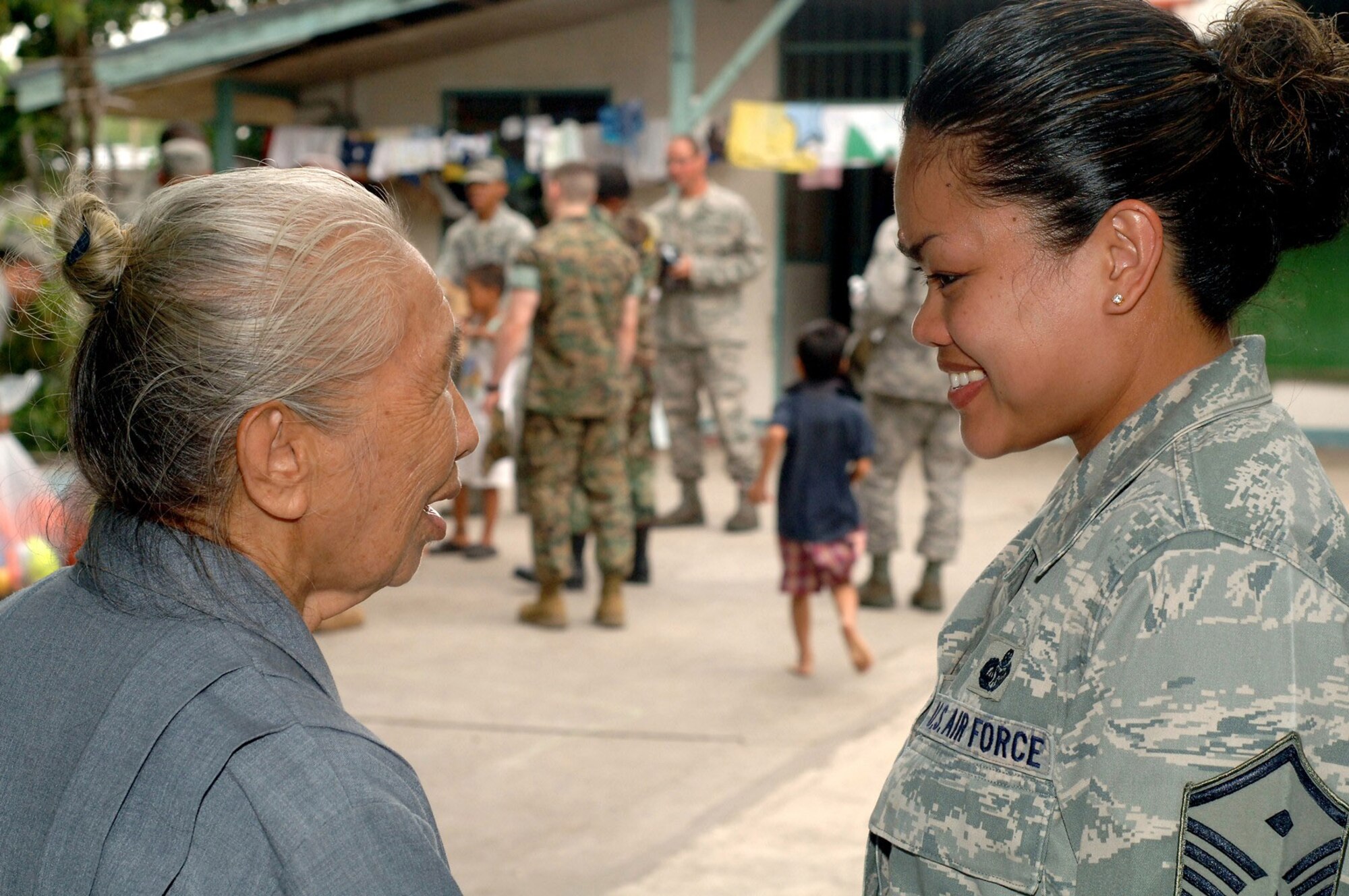 Sister Mary Alessandrina Casas of the Sisters of Mary of the Encharist (left) greets Master Sgt. Rosene Goods and other Airmen during their visit to Duyan Ni Maria orphanage April 25 at Angeles City, Philippines. Airmen donated school supplies and athletic equipment as part of a volunteer community relations. Sergeant Goods is the first sergeant for all Air Force personnel participating in Exercise Balikatan 2009. (U.S. Navy photo/Petty Officer 2nd Class Robert Clowney) 

