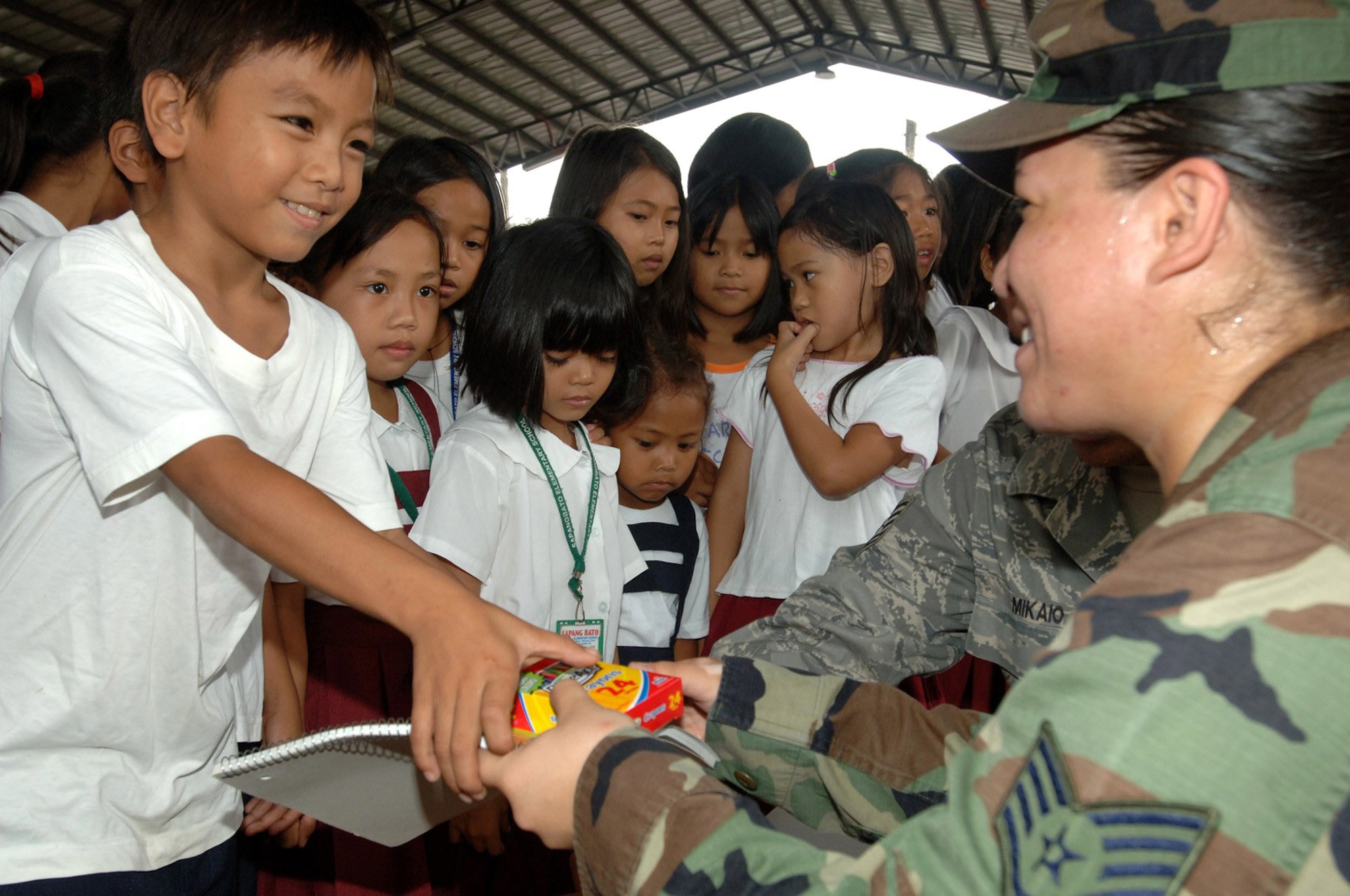Airmen participating in Exercise Balikatan 2009 donated school supplies and athletic equipment to Filipino children from the Sapangbato village community center as part of a volunteer community relations event held April 24 and 25 at Angeles City, Philippines. (U.S. Navy photo/Petty Officer 2nd Class Robert Clowney) 
