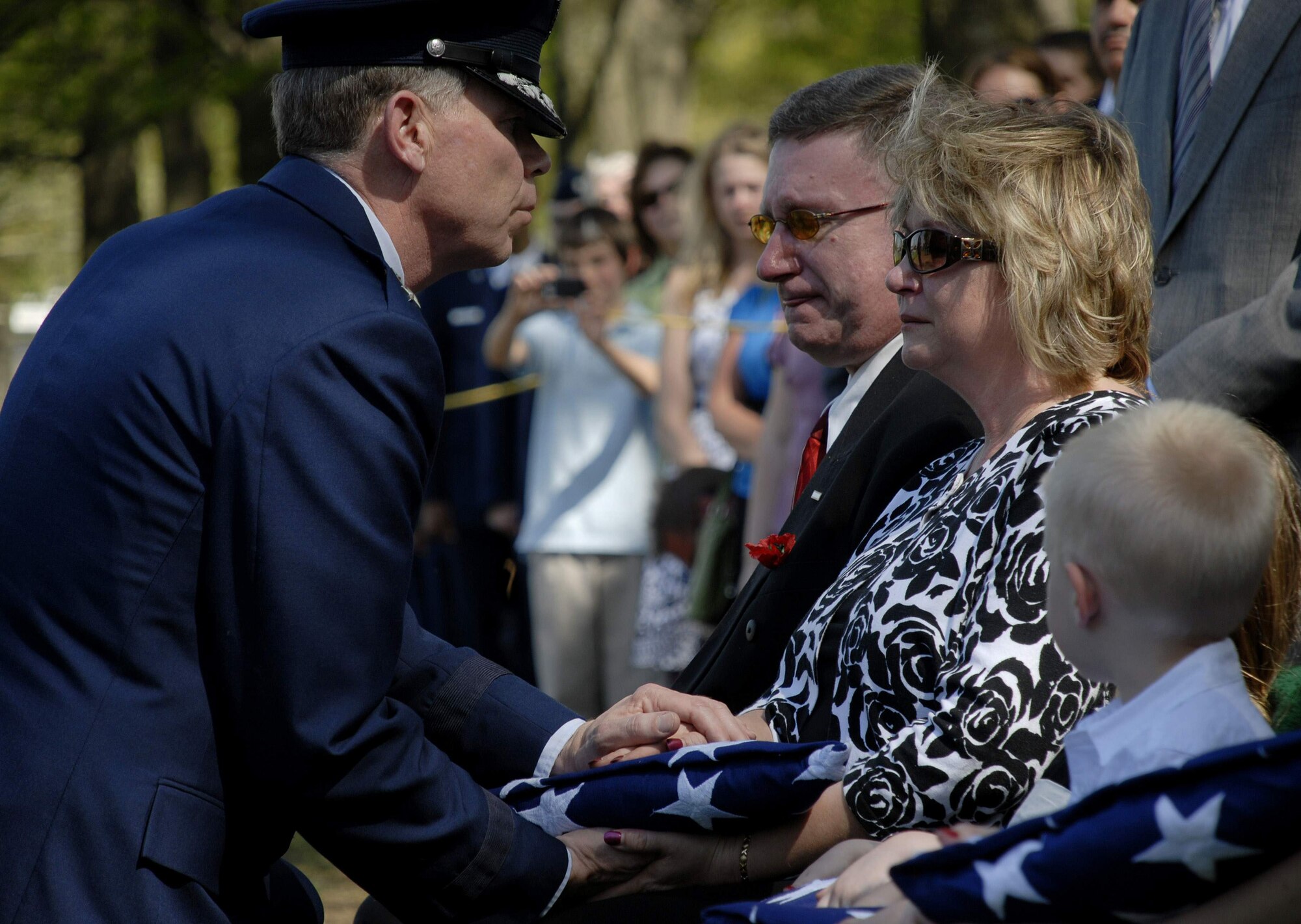 Maj. Gen. Del Eulberg presents the U.S. flag to Treasa Hamilton during the funeral for her son Tech. Sgt. Phillip A. Myers April 27 at Arlington National Cemetery. Sergeant Myers, from Hopewell, Va., was killed April 4 in Afghanistan by an improvised explosive device. His family was the first to allow media coverage of the dignified transfer of remains at Dover Air Force Base, Del., since Defense Secretary Robert Gates lifted the 1991 ban April 6. General Eulberg is the Air Force civil engineer.  (U.S. Air Force photo/Master Sgt. Stan Parker)
