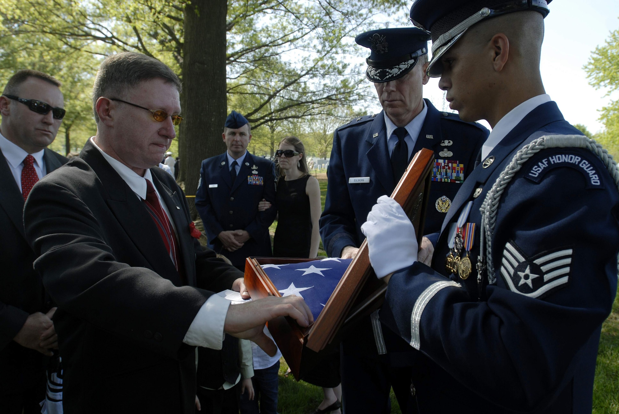 Eddie Myers places a folded flag in a shadow box following the funeral for his son, Tech. Sgt. Phillip A. Myers, April 27 at Arlington National Cemetery. Sergeant Myers, from Hopewell, Va., was killed April 4 in Afghanistan by an improvised explosive device. His family was the first to allow media coverage of the dignified transfer of remains at Dover Air Force Base, Del., since Defense Secretary Robert Gates lifted the 1991 ban April 6. (U.S. Air Force photo/Master Sgt. Stan Parker)