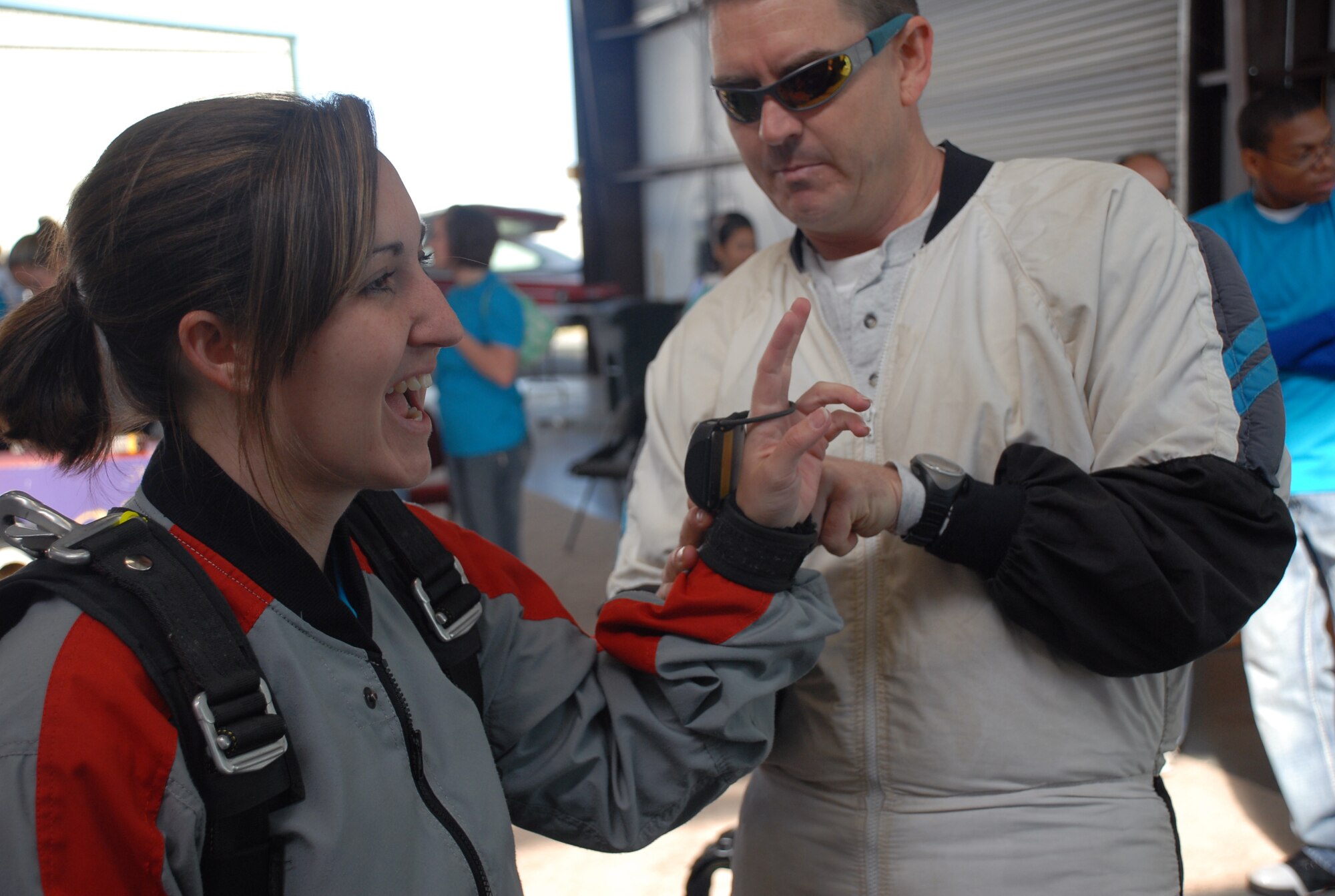 Skydiving instructor Maj. Holt Durham, Det. 5, helps Capt. Michelle Willison, 7th Space Warning System, gear up before making a tandem skydiving jump at the Lincoln Airport April 24. Captain Willison was one of 36 Beale members who participated in the  Jump Into Prevention day hosted by Beale's Sexual Assault Awareness Coordinator in honor of sexual assault prevention month. (Photo by Staff Sgt. Sarah Gregory)