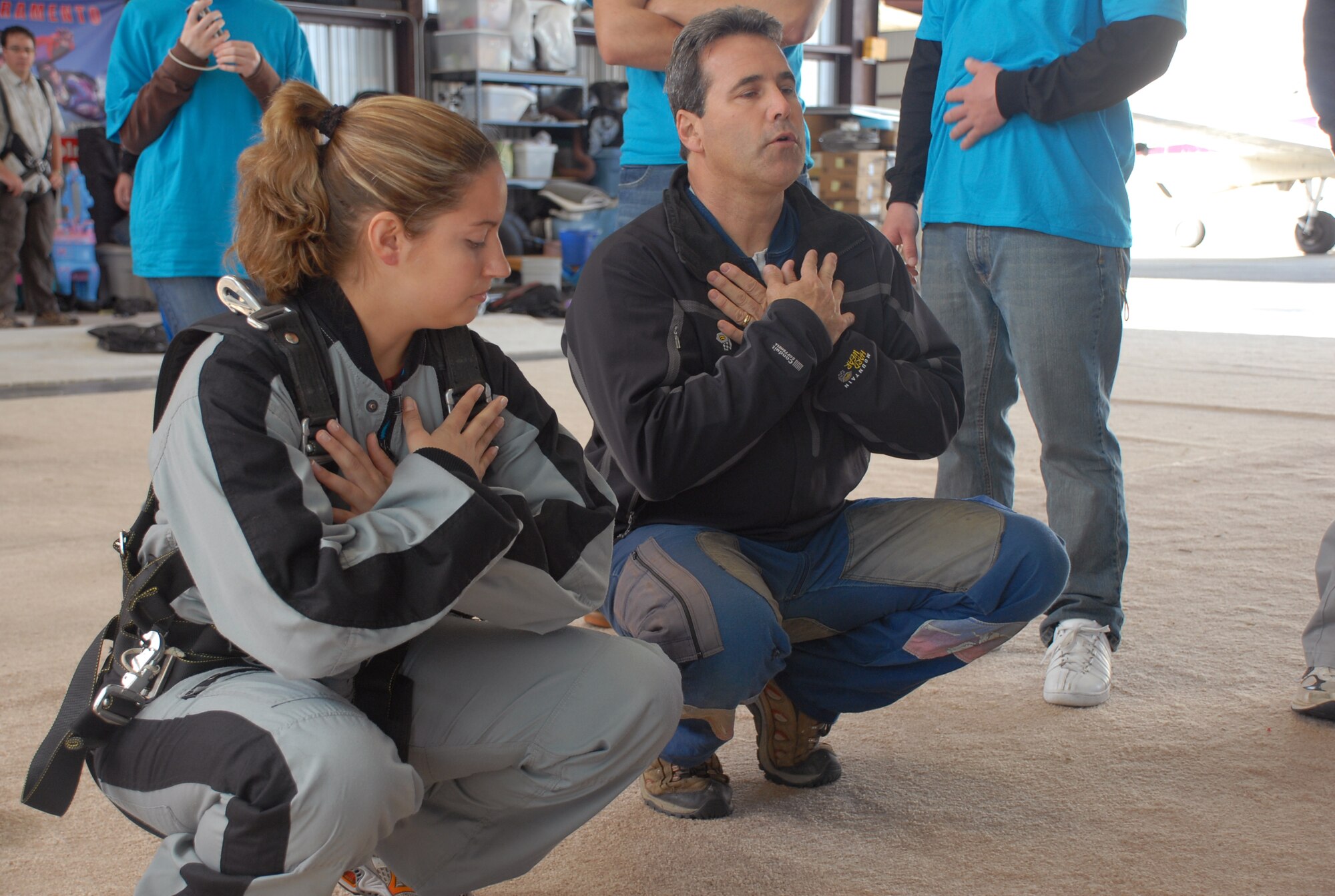 A skydiving instructor shows 1st Lt. Bryony Veater, 7th Space Warning System, how to position herself before jumping out of a plane at 14,000 feet. Lieutenant Veater was one of 36 Beale members who participated in the April 24 Jump Into Prevention day hosted by Beale's Sexual Assault Awareness Coordinator in honor of sexual assault prevention month. (Photo by Staff Sgt. Sarah Gregory)