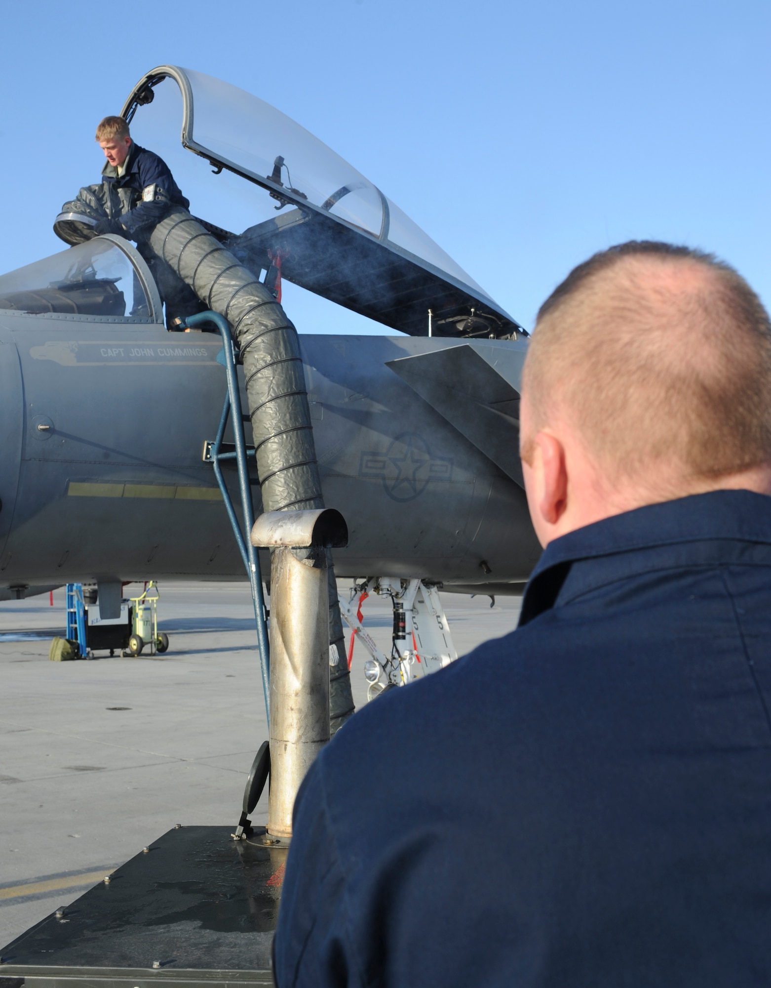 ELMENDORF AIR FORCE BASE, Alaska -- Airman 1st Class Louis Hall and Staff Sgt Robert Jackson both from the 19th Aircraft Maintenance Unit, warms the cockpit of an F-15 Eagle, preparing it for takeoff during RED FLAG-Alaska 09, Tuesday April 28. This exercise enables flying squadrons to enhance their fighting capabilities by flying simulated combat sorties in a realistic threat environment.(U.S. Air Force photo/ Senior Airman Matthew Owens)