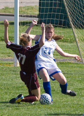 Jessica Ringer (right), Air Base Middle School Falcon defender, blocks Jaimey Rouse, Milford Middle School Buccaneer forward, goal attempt during a game played at Dover Air Force Base April 27. The Buccaneers beat the Falcons 5 ? 0 in the game. (U.S. Air Force photo/Tech. Sgt. Kevin Wallace)