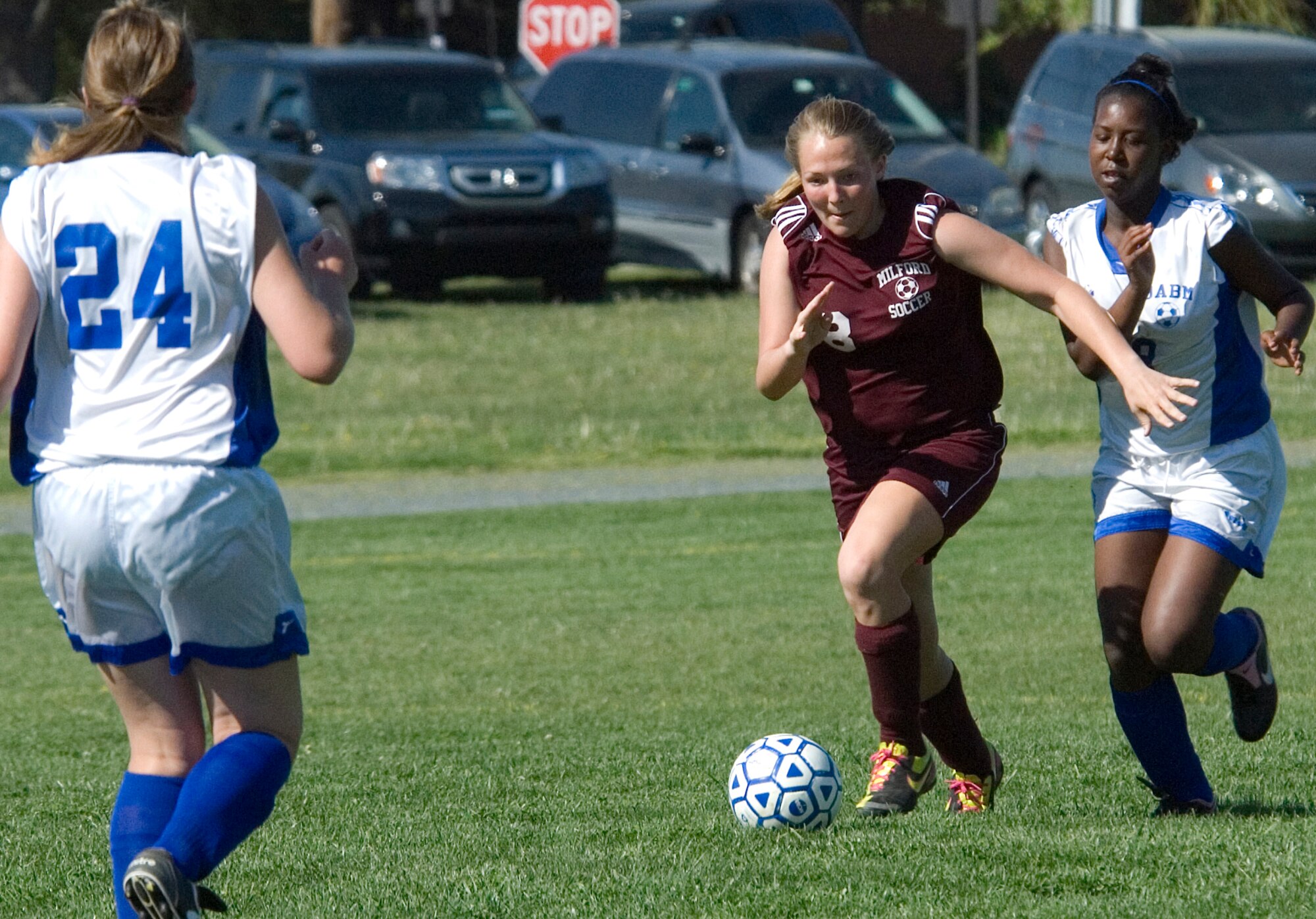 Bekah Yanacek (center), Milford Middle School Buccaneer defender and goalie, dribbles the ball as Air Base Middle School Falcons, Jessica Ringer (left) and Aisha Hallman, attempt to stop her drive toward their goal during a game played at Dover Air Force Base April 27. The Buccaneers beat the Falcons 5 ? 0 in the game. (U.S. Air Force photo/Tech. Sgt. Kevin Wallace)