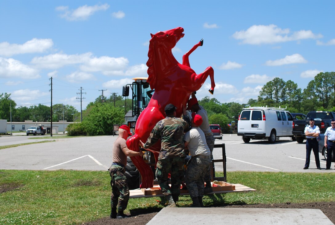 Members of the 560th Red Horse Squadron, Charleston Air Force Base S.C., install the new red horse statue.  The 560 RHS is one of two new units created by the Air Force Reserve, with the other being based at Seymour-Johnson Air Force Base in North Carolina. (Air Force photo/Tanya Trejo)