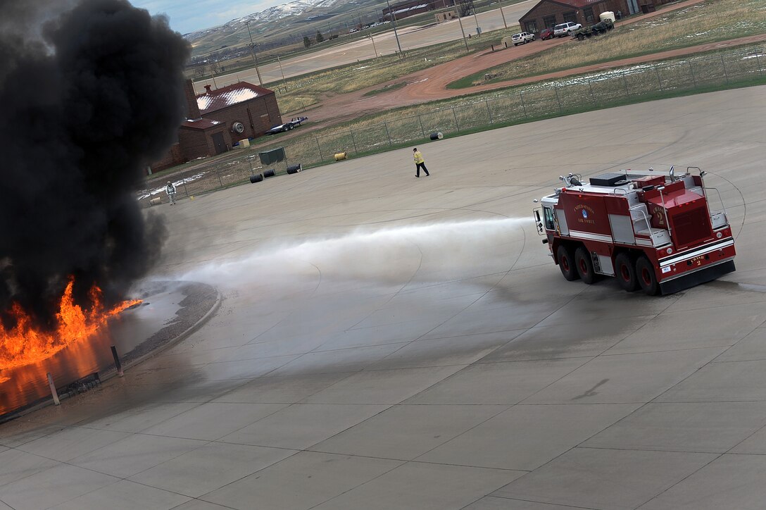 Firefighters from the 28th Civil Engineer Squadron train volunteers from Aberdeen, S.D., on how to put out an aircraft fire here, April 27. This training ensured other firefighters in the state are qualified to keep their community safe from fires. (U.S. Air Force photo/Airman 1st Class Joshua J. Seybert)