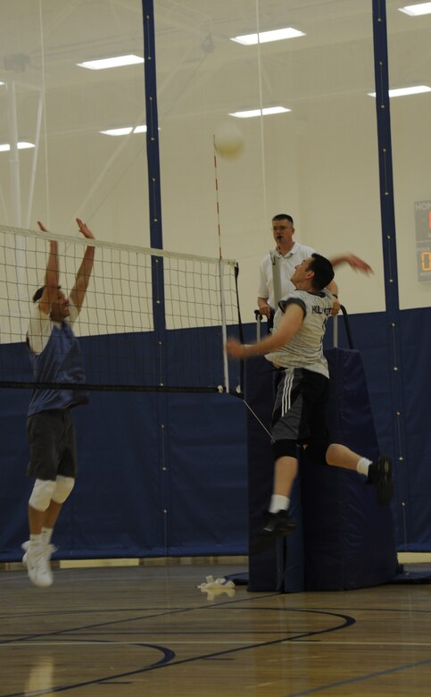 VANDENBERG AIR FORCE BASE, Calif. --  Battling at the net, Greg Caresio, a member of the 30th Launch Group team, attempts to block a  spike from Joshua Peargin, a member of the 30th Operations Group team, during an intramural volleyball game recently.  The match went to three games, with the 30th OG closing the deal at 15-7. (U.S. Air Force Photo/ Senior Airman Stephanie Longoria)
