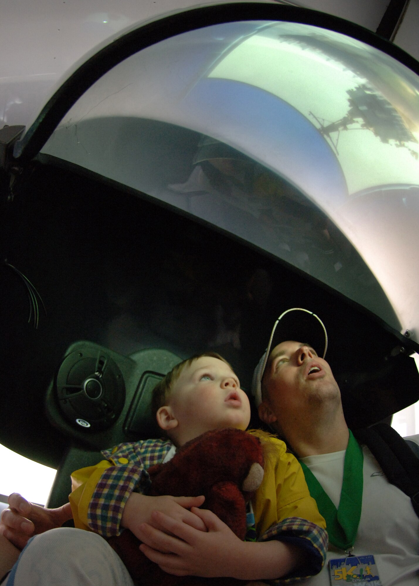 SCOTT AIR FORCE BASE, Ill. --Brad Wyckhouse and his 2-year-old son stare in awe at the Accelerate Your Life simulator. (Photo by Mass Communication Specialist 1st Class John Collins)