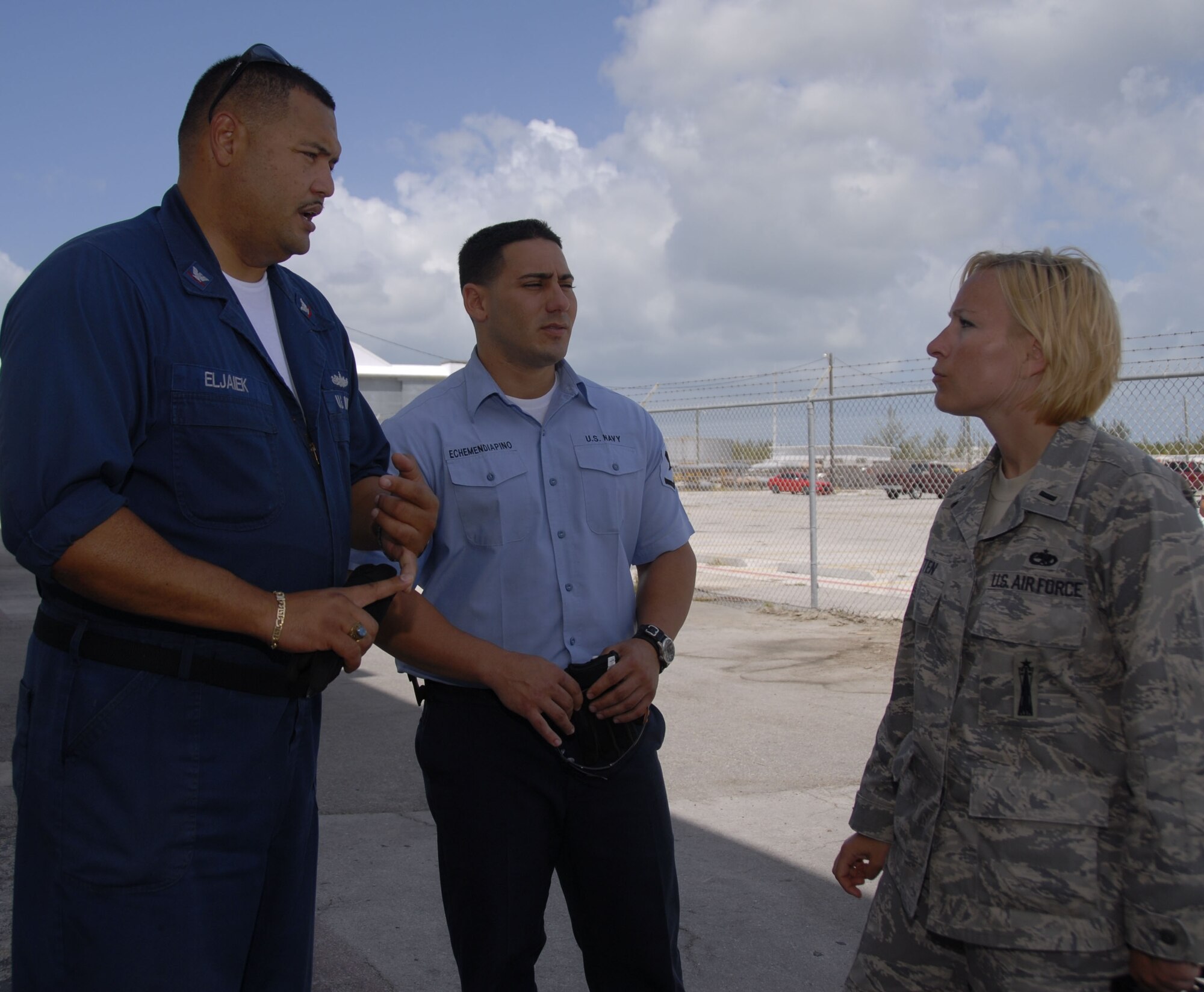 Petty Officers 3rd Class Ernesto Eljaiek and Reynel Echemenia, NAS Key West hazardous materials specialists and fleet liaisons, works with 1st Lt. Christy Kasten, 115th Fighter Wing maintenance officer, on the hangar logistics as the wing prepares to complete their deployment.   The 115th FW participated in an air-to-air combat training skills along side their naval counterparts from the Strike Fighter Squadron 2 (VFA-2), Naval Air Station Lemoore, Calif. during a two-week training mission.  (U.S. Air Force photo by Master Sgt. Dan Richardson, 115 FW/PA)