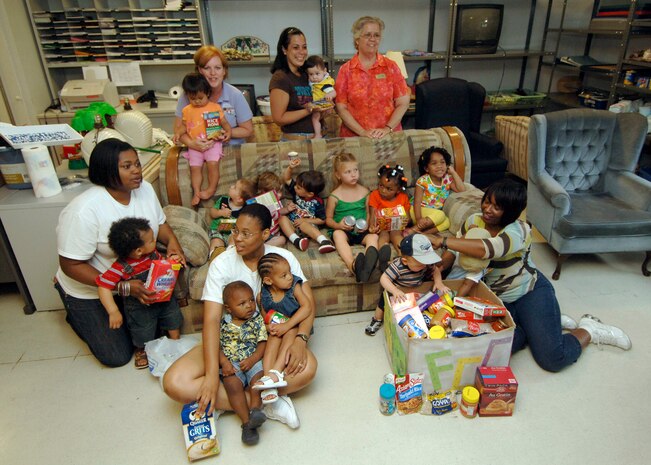Charleston AFB Parents and children gather in the Airman's Attic at the Airman and Family Readiness Center here to donate non-perishable food items during a food drive April 28. As part of April's celebration as Month of the Military Child, the Family Child Care providers collected food from parents to donate to the Airman's Attic. (U.S. Air Force photo/Senior Airman Timothy Taylor)