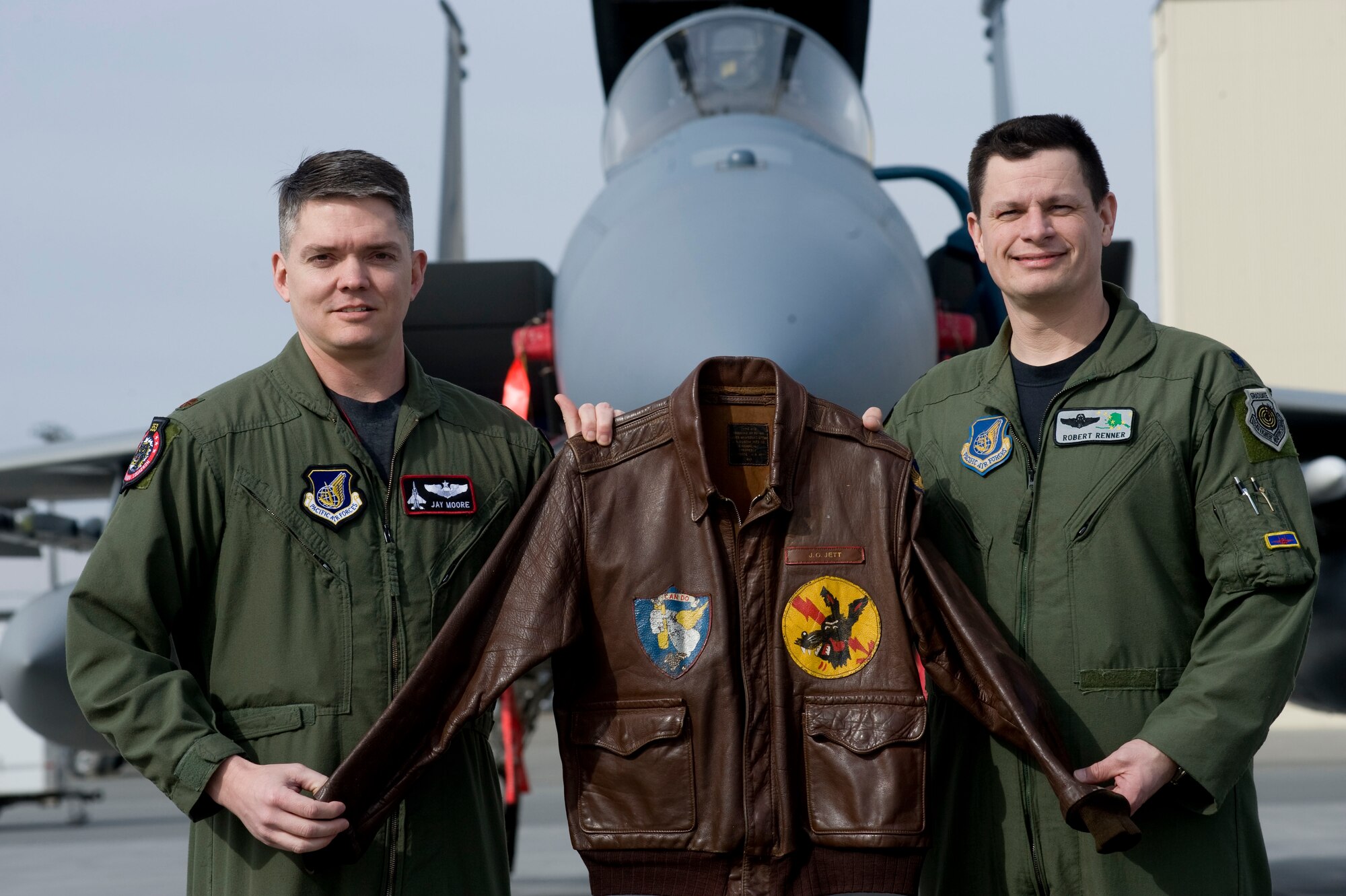 ELMENDORF AIR FORCE BASE, Alaska--Major Jay Moore(left) and Lt. Col. Robert Renner(right) hold Moore's grandfathers historic WWII Jacket. The jacket has traveled from England to be returned to Moore's family.(U.S. Air Force photo by Senior Airman Jonathan Steffen)