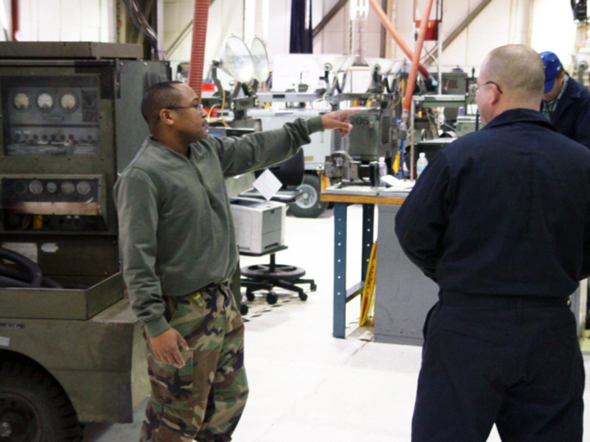 Tech. Sgt. Fulton Cobbs, 436th Maintenance Squadron  Aerospace Ground Equipment supervisor, directs a fellow AGE mechanic, Senior Airman Michael Wise, on a task he must complete as part of his daily mechanic duties. While most units’ sole focus was on the Unit Compliance Inspection, the 436th Maintenance Group and their underlying units were challenged with the UCI in conjunction with the Logistics Standardization and Evaluation Program inspection. (U.S. Air Force photo/Staff Sgt. Christopher Jensen)