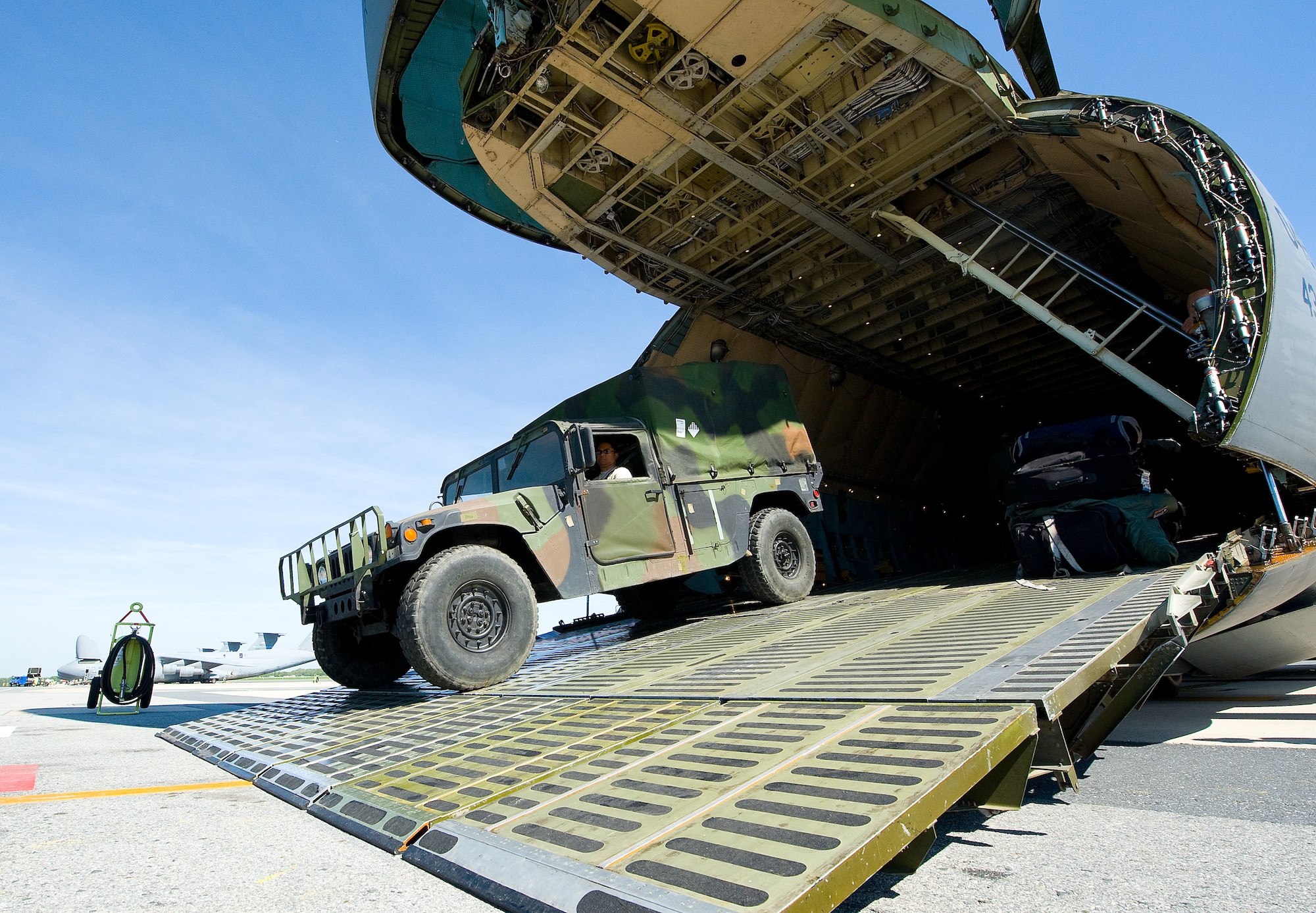 Port Dawgs offload a Humvee from a C-5 Galaxy at Dover Air Force Base, April 28. More than 17,000 tons of total cargo was processed through the Super Port during the month of March. (U.S. Air Force photo/Tom Randle)