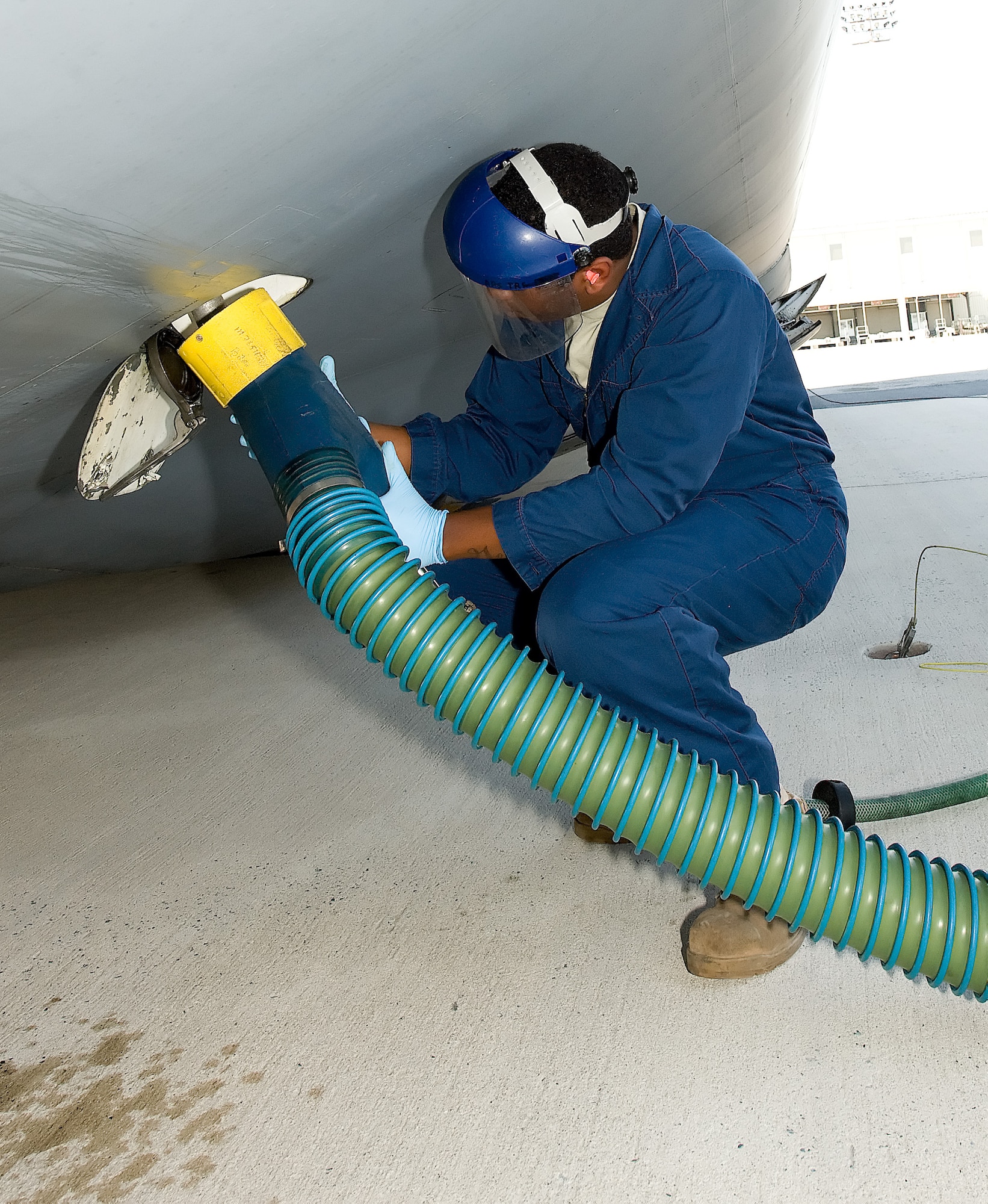 Senior Airman Johnathan Anderson, 436th Aerial Port Squadron, connects a drainage tube to a C-5 Galaxy to remove waste from the lavatories April 28. Fleet Airmen replenish comfort items and clean the interior of the aircraft before departure. (U.S. Air Force photo/Jason Minto)
