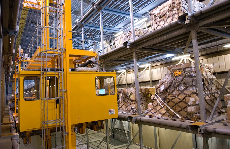 The Mechanized Material Handling System moves past rows of pallets searching for the correct piece of cargo to load on a K-Loader at Dover Air Force Base. After cargo has been palletized, the MMHS stores the cargo until the pallet can be loaded onto an aircraft. (U.S. Air Force photo/Jason Minto)