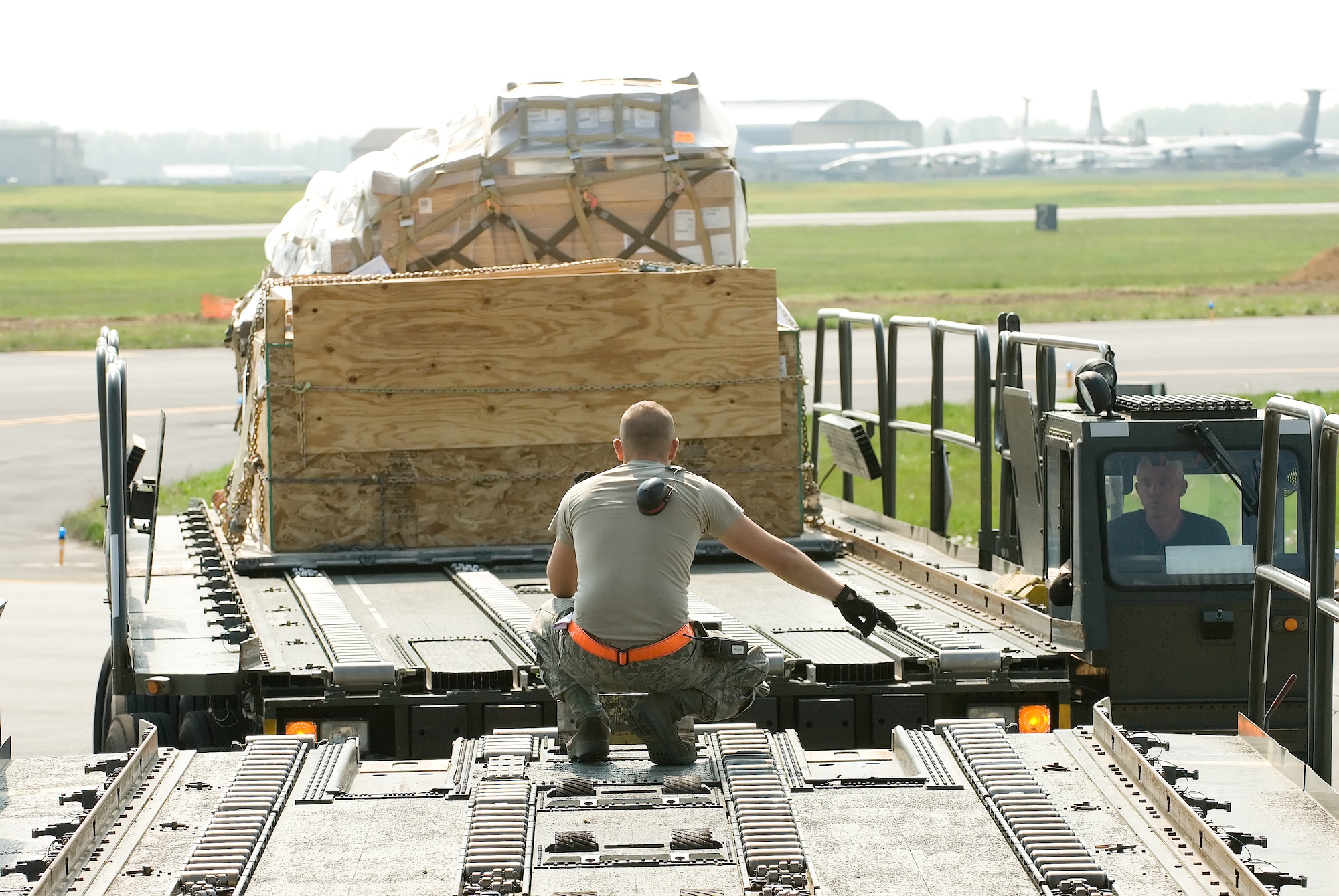 Airman 1st Class Brenten Chrans, 436th Aerial Port Squadron, lines up a K-loader to load cargo onto a C-17 Globemaster aircraft at Dover Air Force Base, Del. The 436th APS performed more than 500 uploads and downloads on C-17 and C-5 Galaxy aircraft during the month of March. (U.S. Air Force photo by Jason Minto/Released)