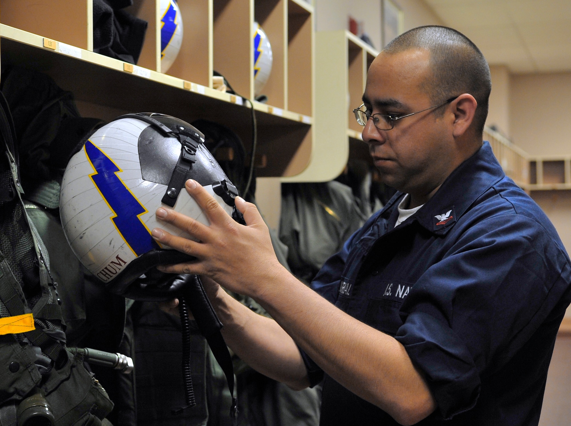 Navy Petty Officer 2nd Class Joseph Villarreal performs a visual inspection of a helmet during Red Flag-Alaska April 23 at Eielson Air Force Base, Alaska. Red Flag-Alaska is a Pacific Air Forces-directed field training exercise for U.S. and coalition forces flown under simulated air-combat conditions. Petty Officer Villarreal is an aviation life support equipment technician assigned to Naval Air Station Whidbey Island, Wash. (U.S. Air Force photo/Senior Airman Christopher Boitz) 
