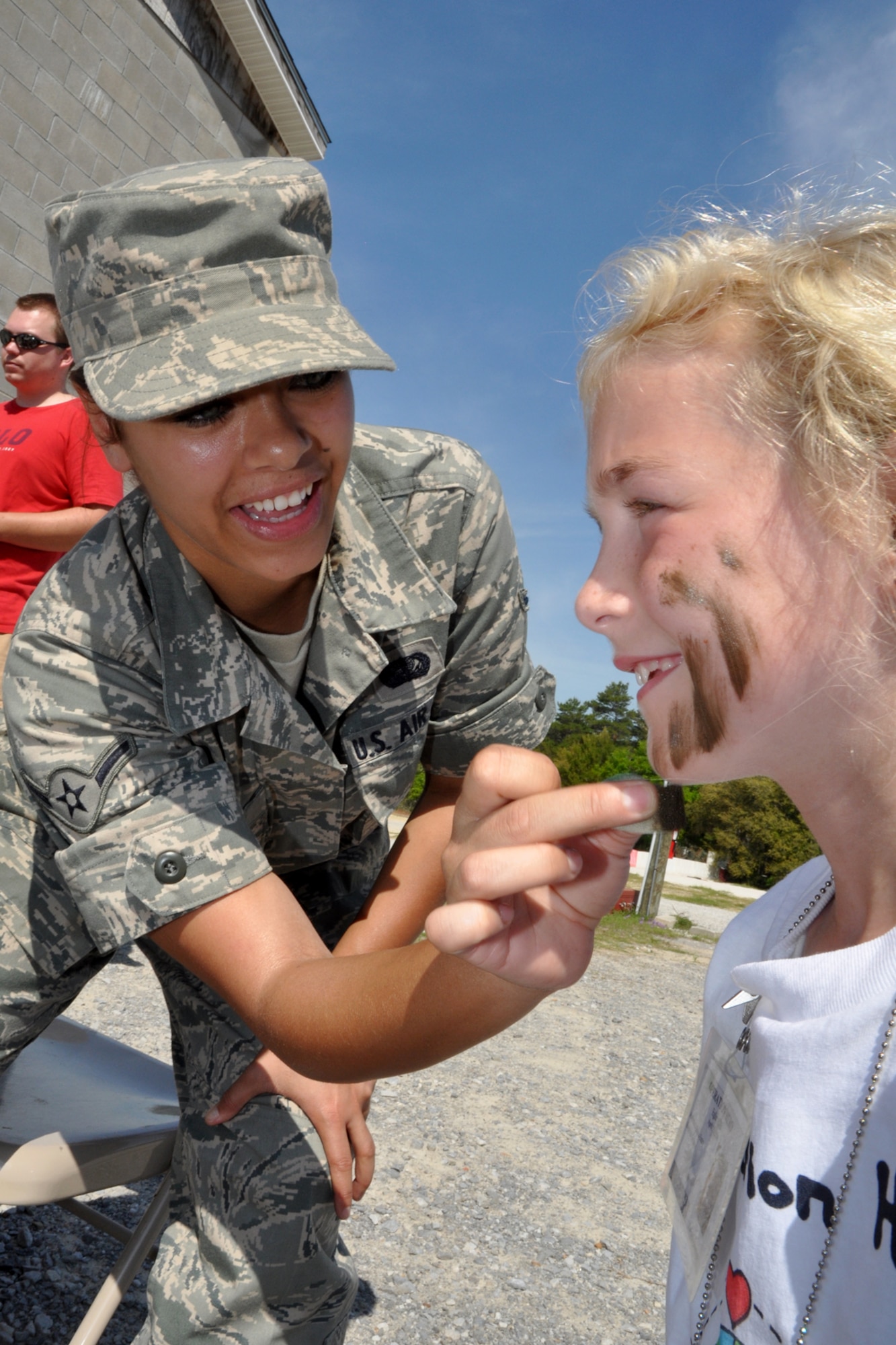 EGLIN AIR FORCE BASE, Fla. -- Airman Erin Rich, 96th Services Squadron, applies camoflauge facepaint to Kassandra Johnson, 7, during Operation Hero, April 25. 163 children of Team Eglin personnel got the opportunity to experience the deployment process April 25, during Operation Hero. The event helped children to understand what their parents must endure during deployment and alleviated the anxiety that may accompany a loved one's departure. (U.S. Air Force photo/ Airman Anthony Jennings)