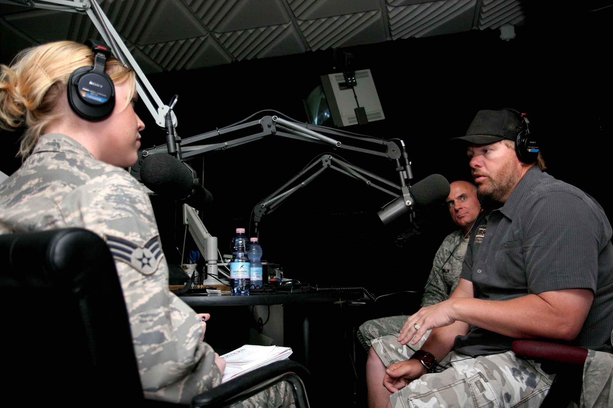 Brig. Gen. Craig Franklin, 31st Fighter Wing commander, and country music superstar Toby Keith, are interviewed by Senior Airman Caitlin Jones on American Forces Network Aviano's ZFM 106 morning show at Aviano Air Base, Italy, April 29.  Mr. Keith just returned from Afghanistan where he was entertaining the troops on his USO sponsored "America's Toughest Tour 2009".  He stopped by Aviano before continuing the tour with a concert at Camp Darby, Italy, April 29 and U.S. Army Garrison Vicenza, Italy April 30.  (U.S. Air Force photo/Senior Master Sgt. Robert W. Valenca) 