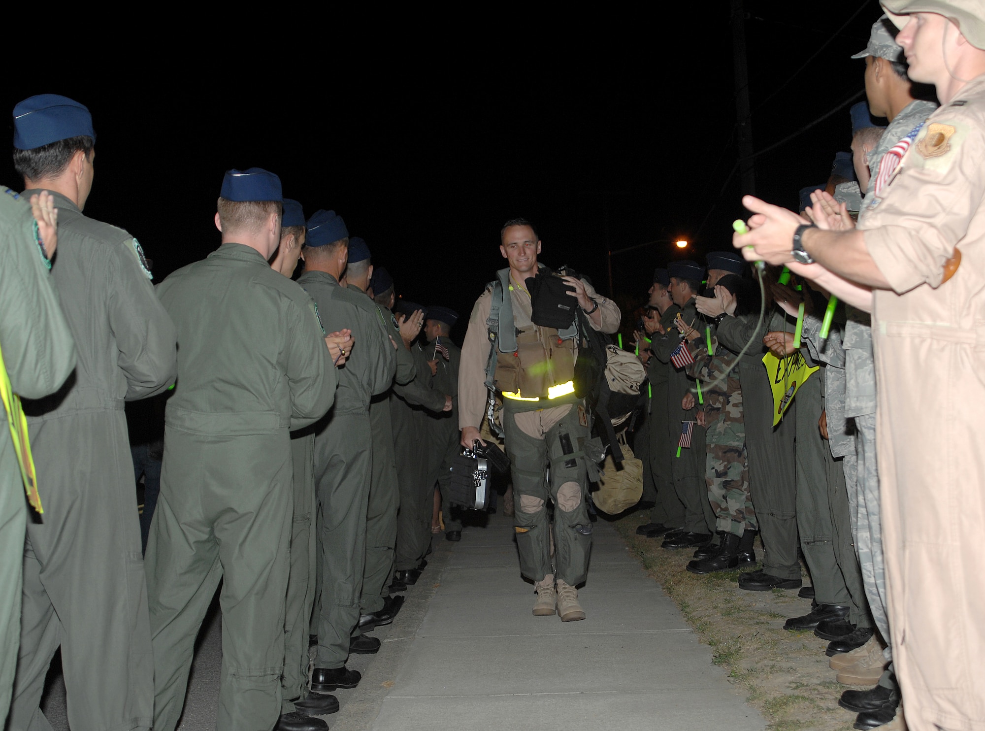 Captain David Gunter, 336th Fighter Squadron aircrew, strides through a gauntlet of well wishers before stepping to an awaiting F-15E Strike Eagle at Seymour Johnson Air Force Base, N.C., April 29, 2009.  More than a dozen fighter aircraft were sent to Afghanistan provide air support to coalition ground forces.  (U.S. Air Force photo by 2nd Lt. Matthew D. Schroff)