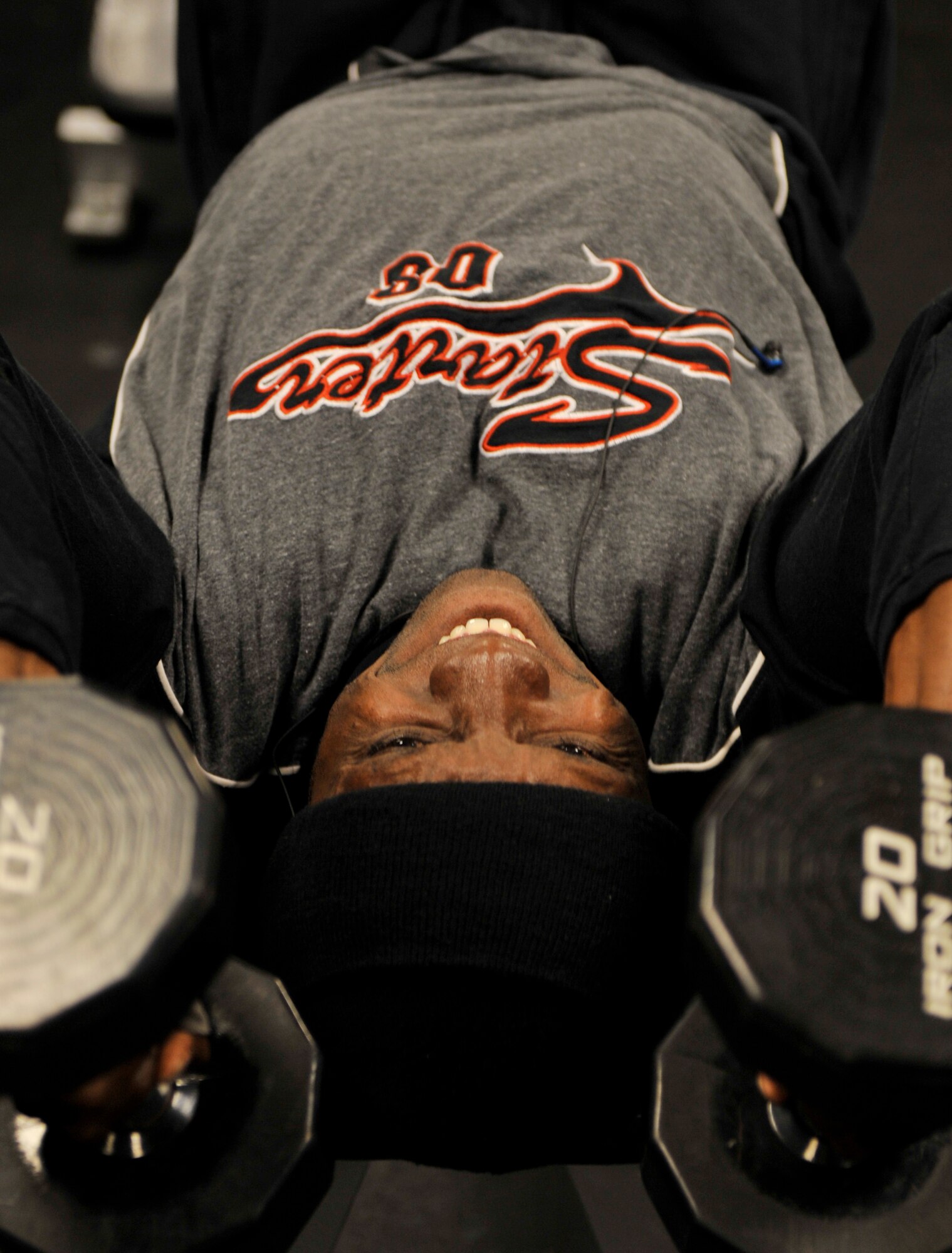 MOODY AIR FORCE BASE, Ga. -- Gerville Harlequin, Valdosta State University student, performs a dumbbell triceps extension here April 1. Mr. Harlequin is training with Charles Gloster, Freedom I Fitness Center personal trainer who is preparing him to compete in his first bodybuilding competition. (U.S. Air Force photo by Senior Airman Schelli Jones)