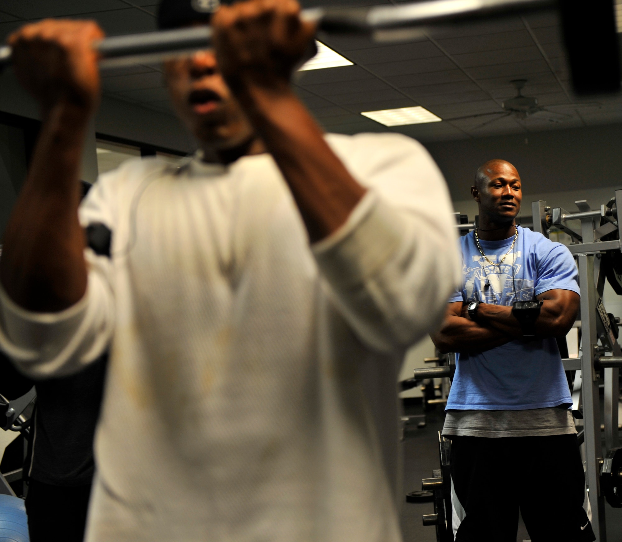 MOODY AIR FORCE BASE, Ga. -- Charles Gloster, Freedom I Fitness Center personal trainer, watches Senior Airman Rodney Bryant, 824th Security Forces Squadron fire team leader, perform a reverse triceps extension here April 1. Airman Bryant was preparing for the Supernatural Bodybuilding and Fitness competition held in Gainesville, Ga. (U.S. Air Force photo by Senior Airman Schelli Jones)