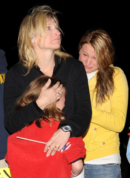 Debbe Jo Allen embraces her two daughters, Taylor and Hannah, as she watches her husband, Lt. Col. Neil Allen, depart from Seymour Johnson Air Force Base, N.C., April 29, 2009. Colonel Allen is the 336th Fighter Squadron commander and is deploying to Bagram Air Base, Afghanistan, for 4 months. (U.S. Air Force photo by Airman 1st Class Gino Reyes) 