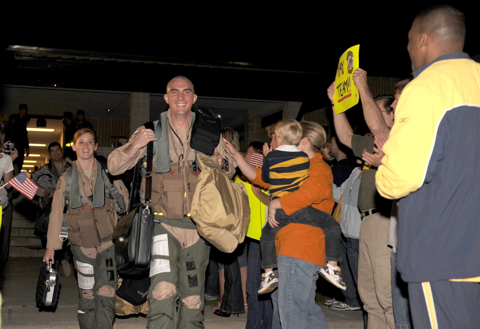 Friends and family cheer 336th Fighter Squadron aviators on the way to their aircraft at Seymour Johnson Air Force Base, N.C., April 29, 2009. The squadron deployed more than a dozen F-15E Strike Eagles for a 4-month deployment to Bagram Air Base, Afghanistan. This is the squadron's first deployment since returning January, 2008. (U.S. Air Force photo by Airman 1st Class Gino Reyes)