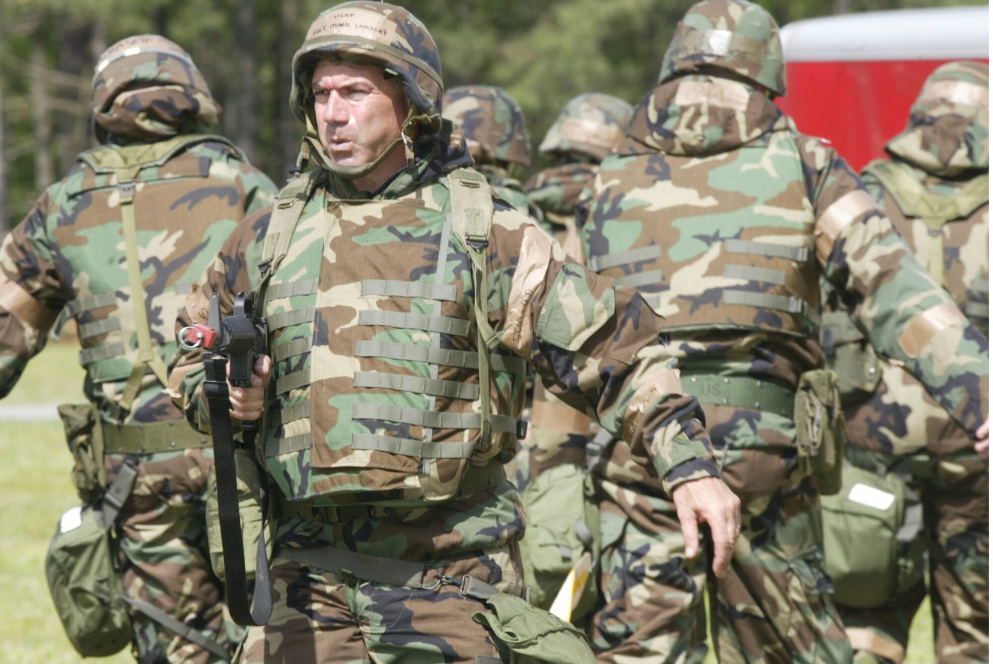 Staff Sergeant Mark Lambert, 94th Civil Engineer Squadron stands guard while a "wounded' Airman is evacuated during a base exercise. (U.S. Air Force photo\Don Peek)