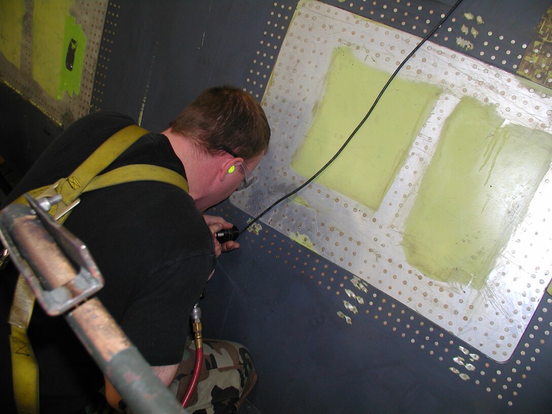 Staff Sgt Kenneth Oellien, 76th Aircraft Maintenance Group, Expeditionary Depot Maintenance Flight, microshaves rivets on a B-1B Lancer here, April 23. Members of the 76th Aircraft Maintenance Group Expeditionary Depot Maintenance Flight worked 1,500 man-hours to repair a B-1B Lancer at Ellsworth Air Force Base.(U.S. Air Force photo by Tech. Sgt. William Chapin)