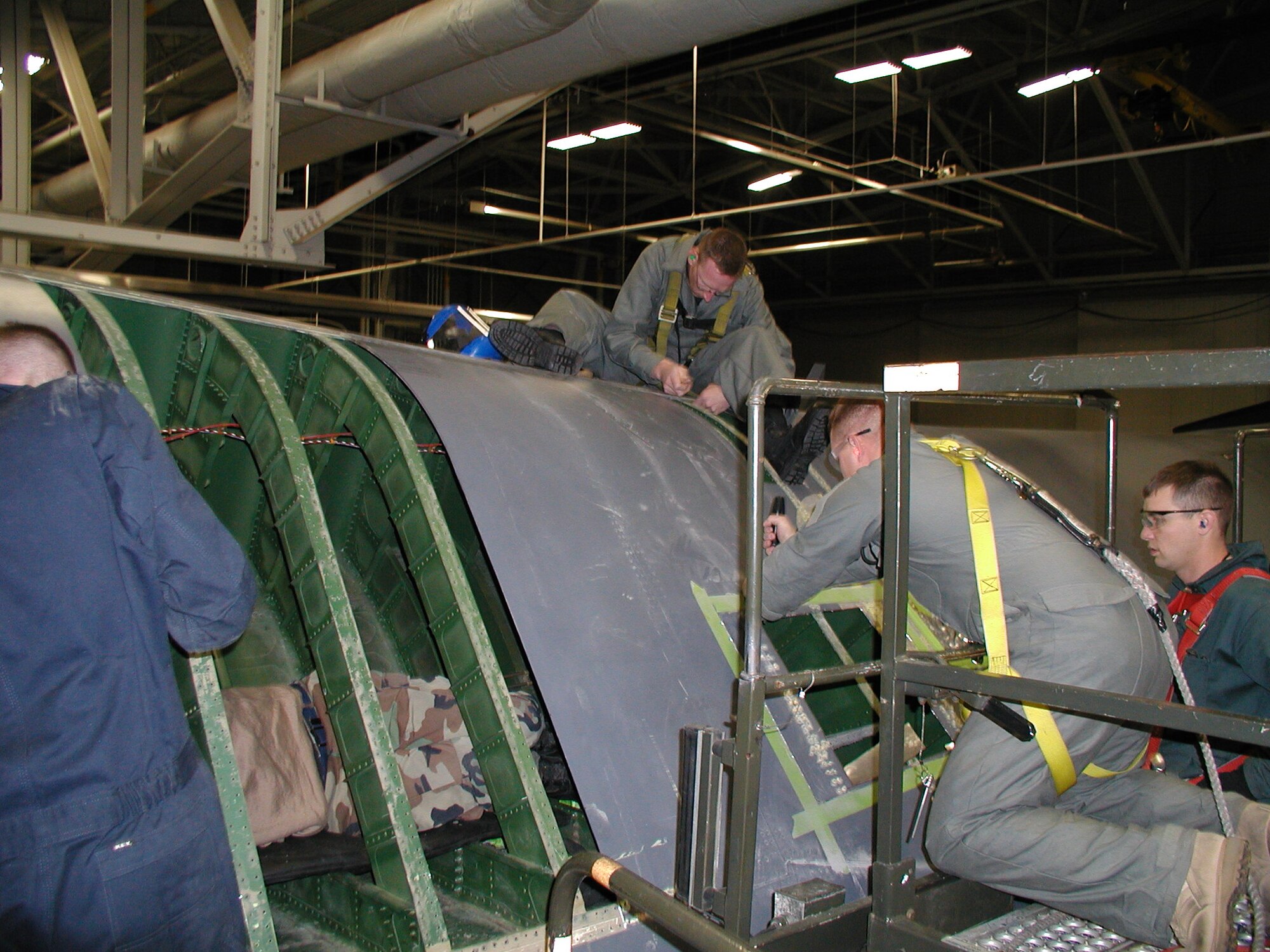 Members of the 76th Aircraft Maintenance Group, Expeditionary Depot Maintenance Flight, remove damage and lay out a rivet pattern on a B-1B Lancer here, April 23. Members of the 76th Aircraft Maintenance Group Expeditionary Depot Maintenance Flight are at Ellsworth Air Force Base to repair a B-1B Lancer using custom-made sections of aircraft skin manufactured at Tinker Air Force Base.(U.S Air Force photo by Staff Sgt. Cody Danker)