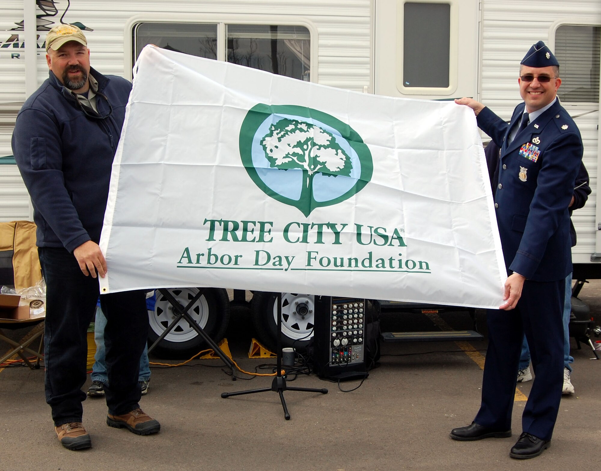 Lt. Col. Timothy Dodge, 341st Civil Engineer Squadron commander (right), accepts the Arbor Day Foundation's Tree City USA award for Malmstrom Air Force Base's 16th year of recognition. Dan Rogers of the Montana Department of Natural Resources from Missoula, Mont., presented the award and a new flag for the base April 25 at the Earth Day Fair in Great Falls. For more information about Tree City USA, visit www.arborday.org/TreeCityUSA. (U.S. Air Force photo/Staff Sgt. Eydie Sakura)