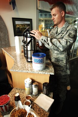 United States Air Force Tech. Sgt. Bret Reinhardt, Defense Media Activity Regional News Center, pours a cup of coffee at the United Service Organizations located in the passenger terminal, Ramstein Air Base, Germany, April 28, 2009. The USO is a private, nonprofit organization whose mission is to support the troops by providing morale, welfare and recreation-type services to our men and women in uniform. (U.S. Air Force photo by Senior Airman Amber Bressler)