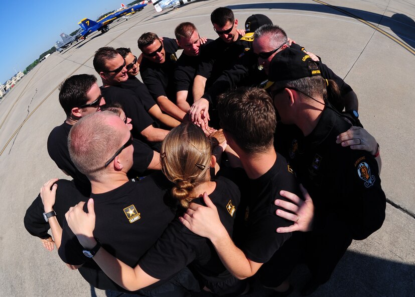 Members of the U.S. Army Golden Knights rally together before suiting up for their jump during the Wings Over Wayne Air Show at Seymour Johnson Air Force Base, April 26, 2009. This is the 50th year the Golden Knights have performed for communities across the country. Unlike the U.S. Navy Blue Angels and Air Force Thunderbirds, the Golden Knights are all enlisted members. (U.S. Air Force photo by Airman 1st Class Rae Perry)