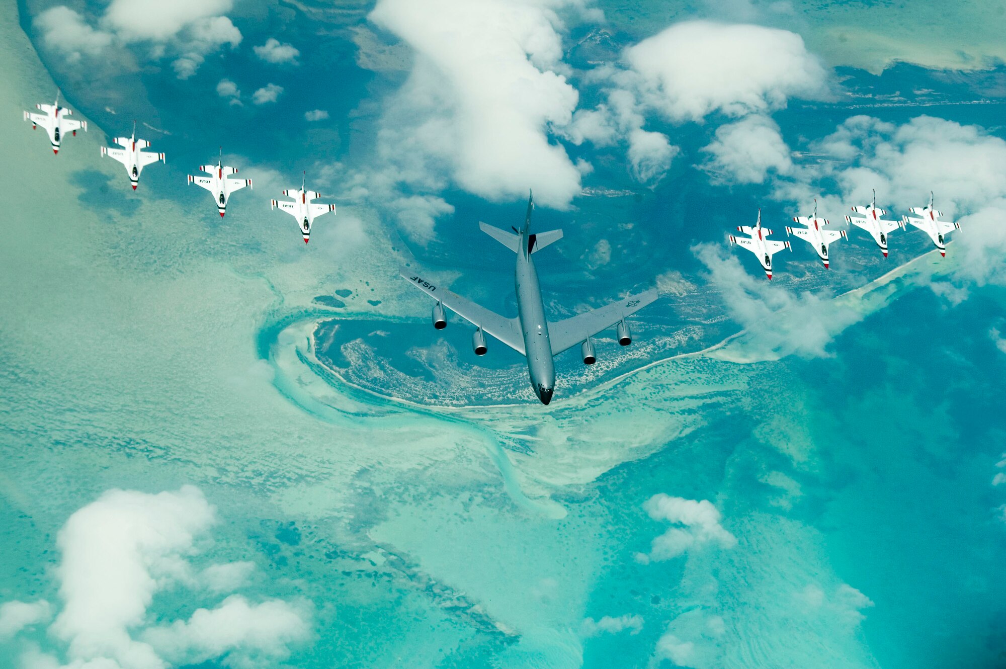 ALTUS AIR FORCE BASE, Okla. – A KC-135 Stratotanker from McConnell Air Force Base, Kansas flies in formation with the Thunderbirds over the Caribbean Sea enroute to an air show held at the new Ceiba Airport, in Ceiba, Puerto Rico April 18 and 19.  Altus and McConnell tankers supported the Thunderbirds by refueling the jets and enabling them to perform at the former U.S. Navy's Roosevelt Roads Naval Base for the first time in 30 years. (U.S. Air Force photo/Airman 1st Class Leandra D. Hernandez)